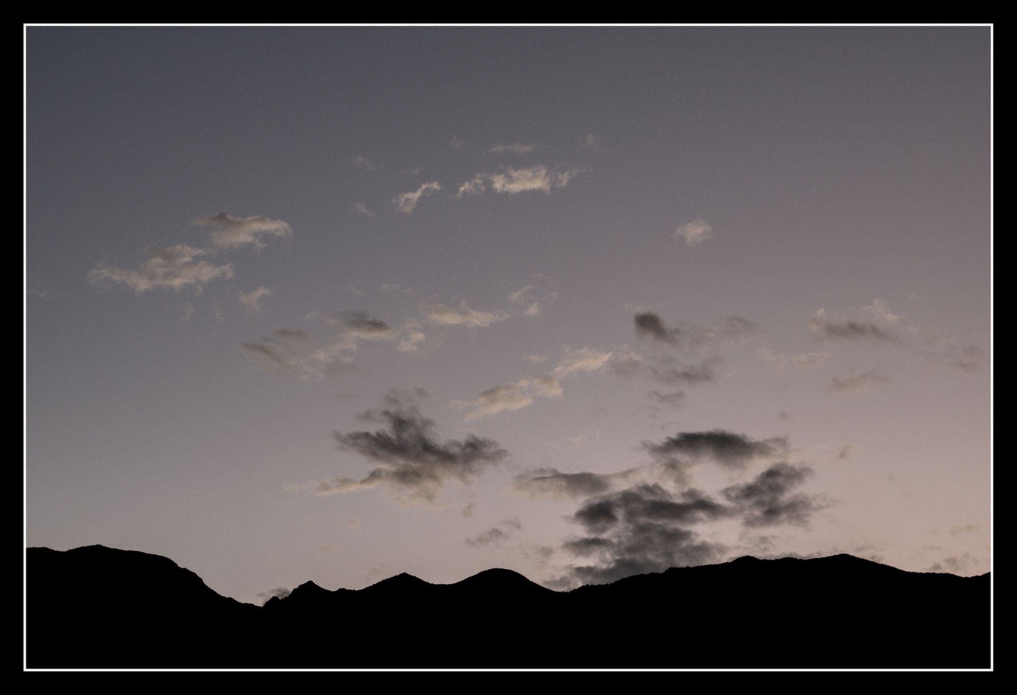 Scattered clouds on a soft gray sky.