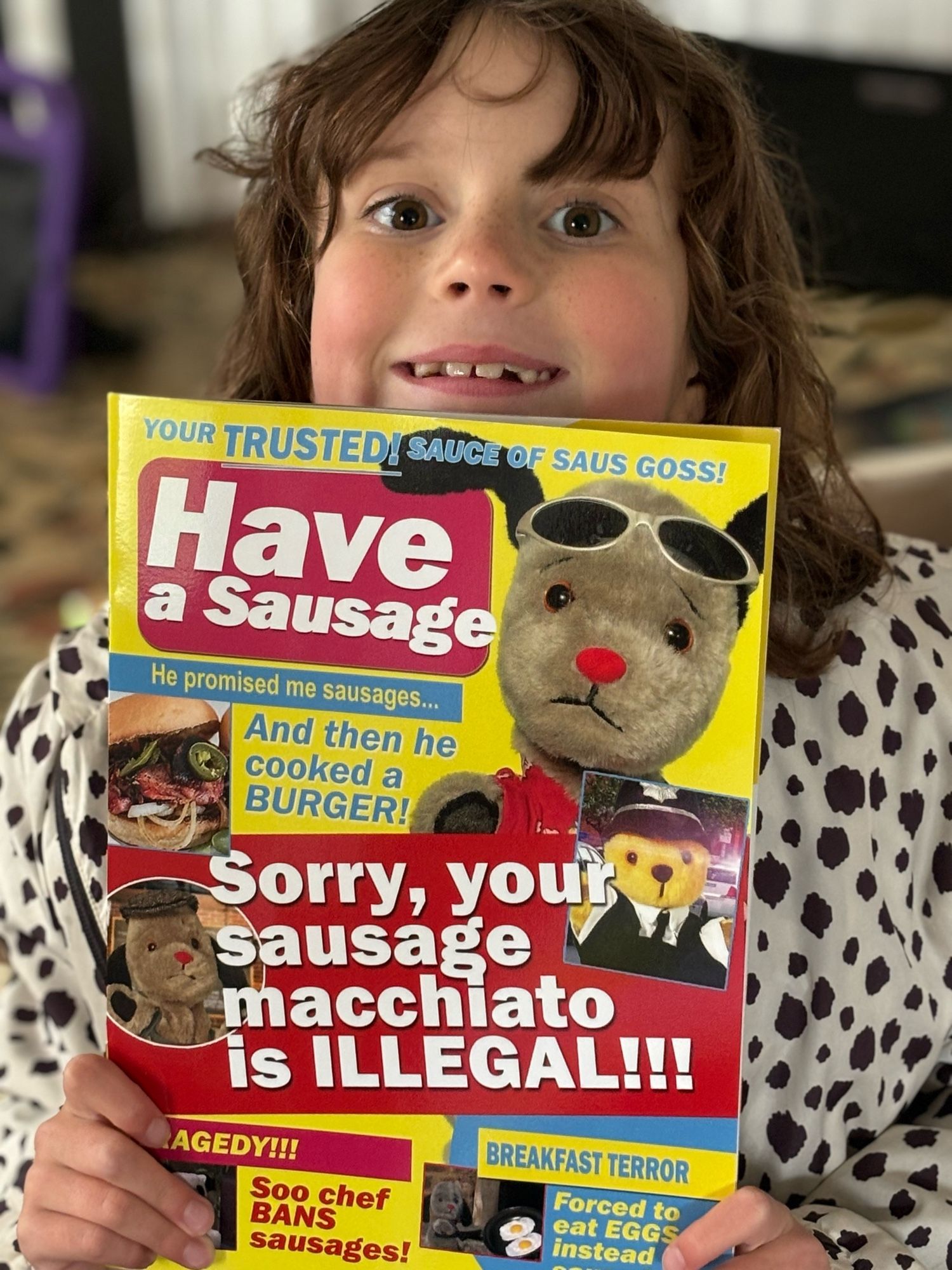 Girl holding debut issue of Have A Sausage magazine, featuring Sweep