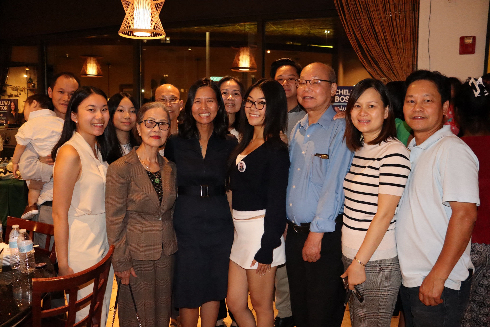 Mayor Wu and a group of supporters pose for a photo in the restaurant. 