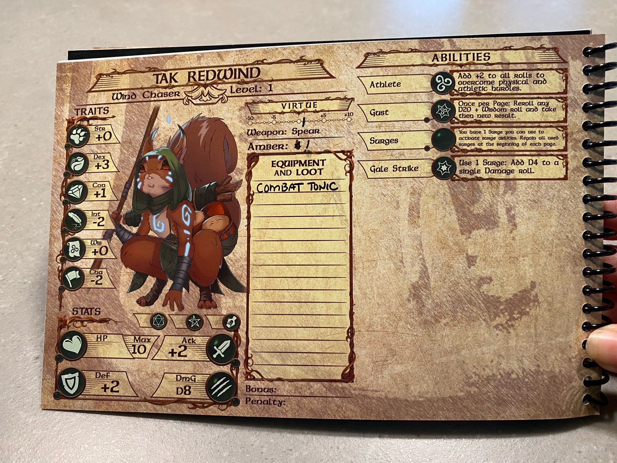 A spiral bound notebook with a character sheet for a squirrel? Or maybe fox, named Tak Redwind. The character is at level 1. 