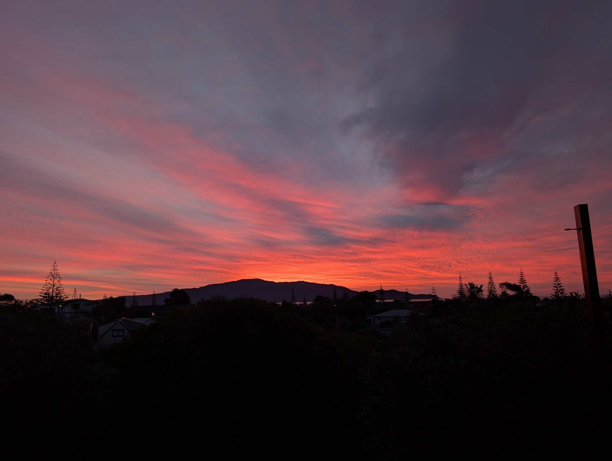 Red skies at sunset against a silhouetted Kāpiti Island 