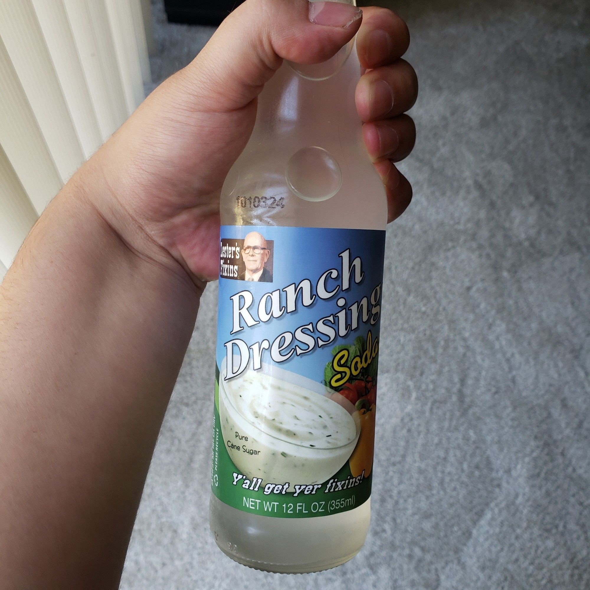 Hand holding ranch dressing soda