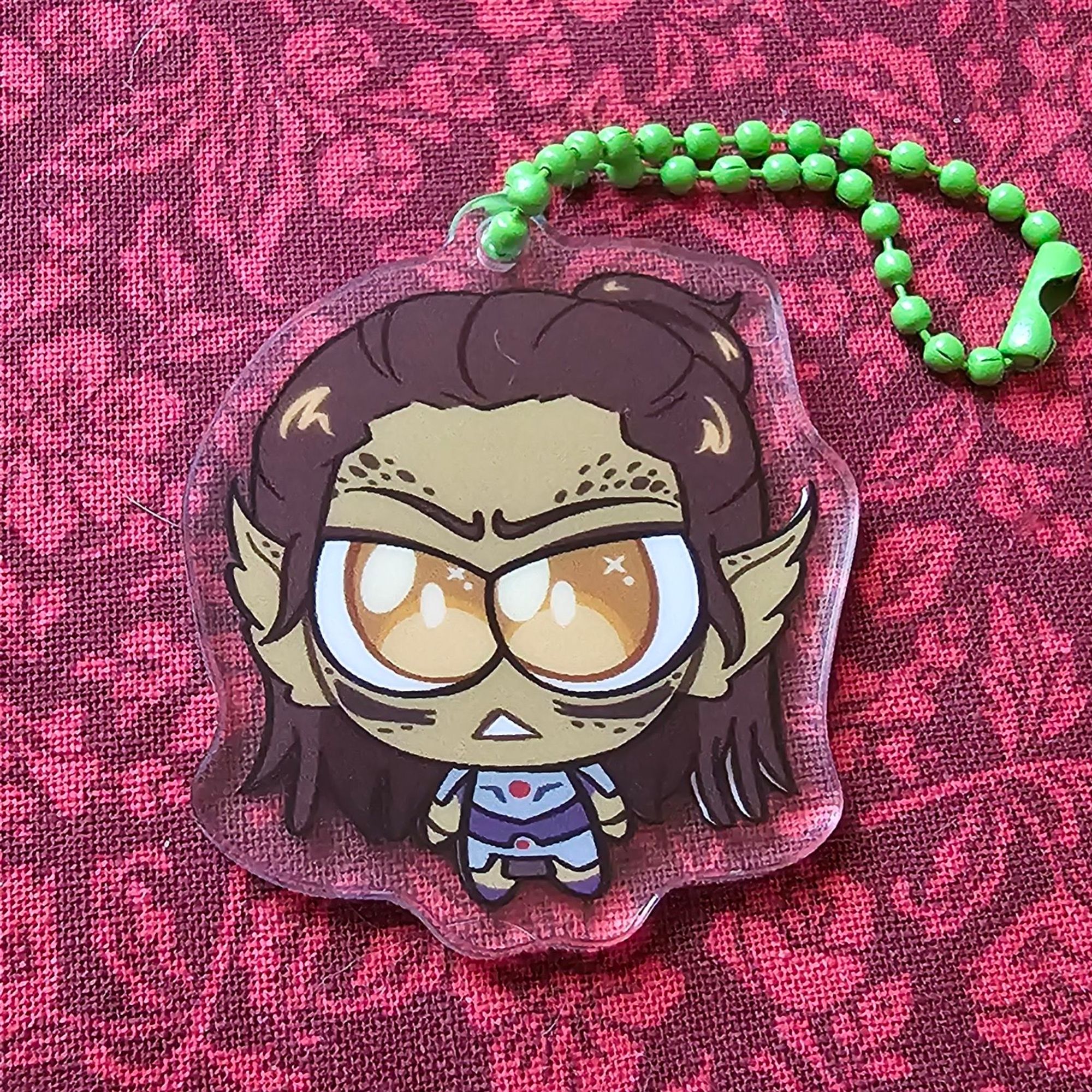 Same artwork, printed as an acrylic charm with a green bean chain.