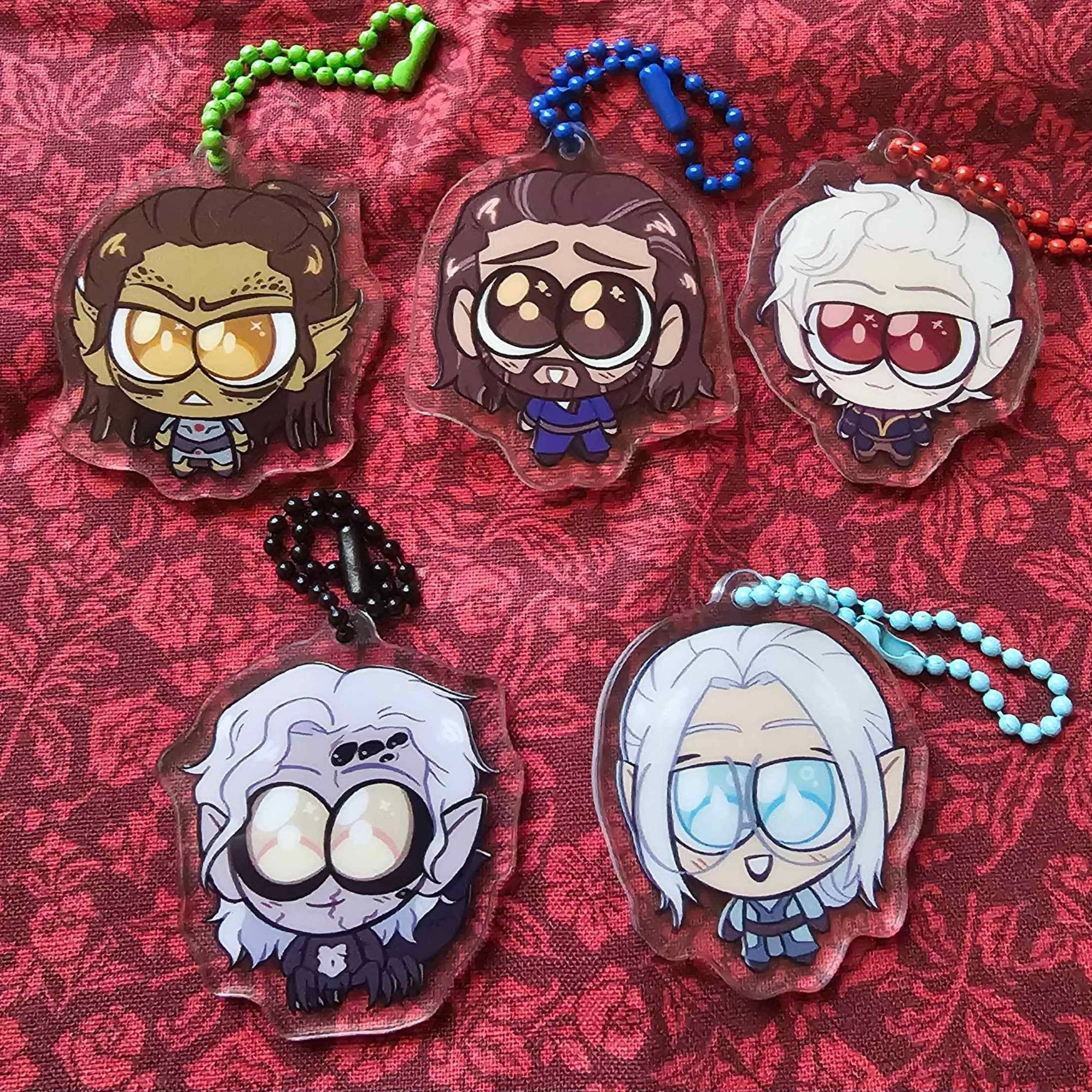 A set of chibi style acrylic charms, featuring the following Baldur's Gate 3 characters: Lae'zel, Gale, Astarion, Kar'niss, and my own Tav, Neuvaine.