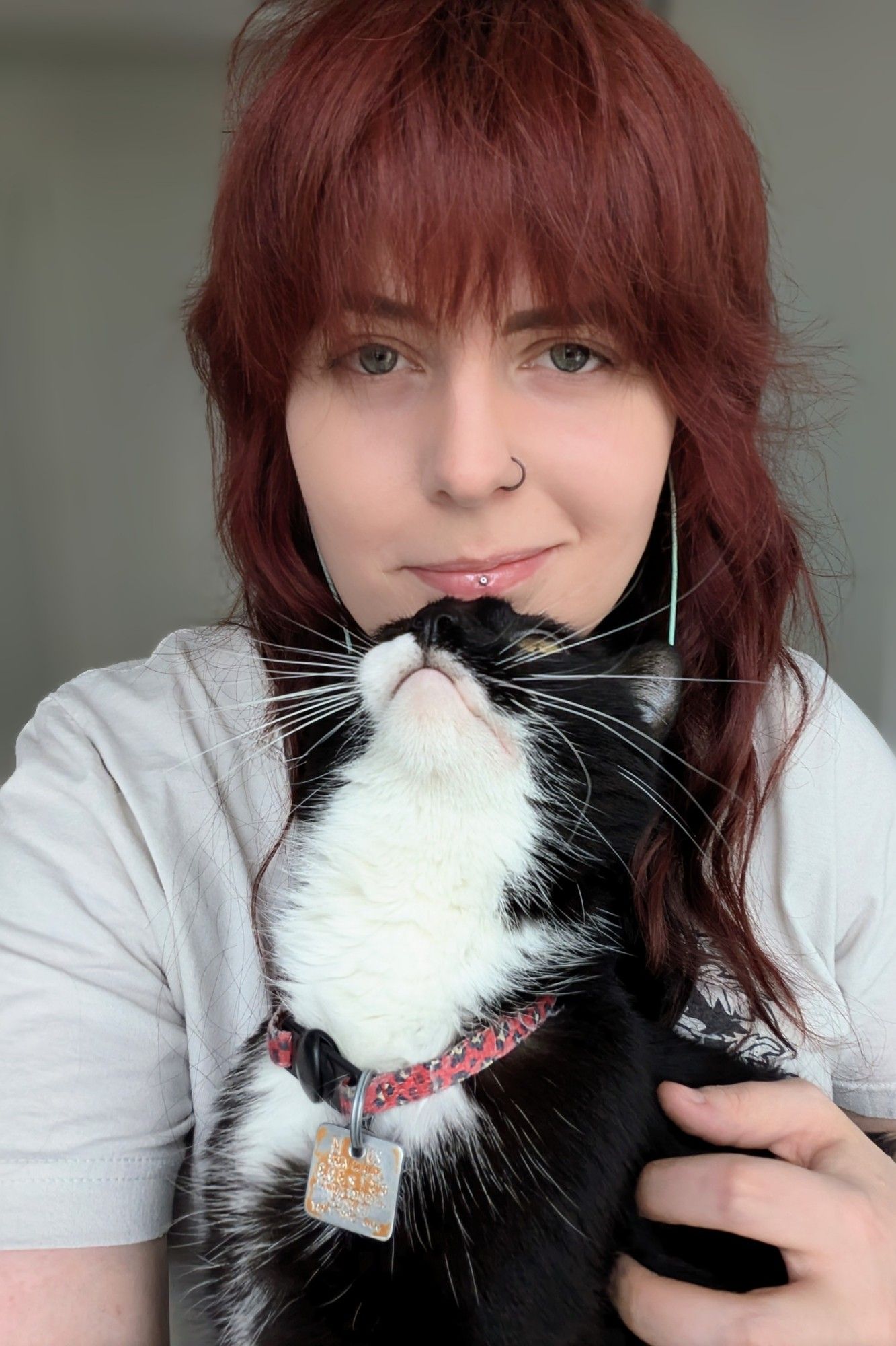 Selfie of me with my tuxedo cat bonking my chin with the top of his head