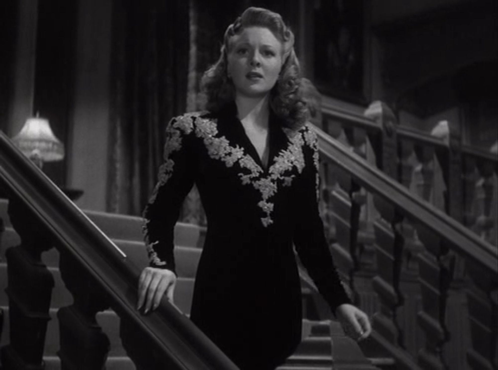 Still from Ghost of Frankenstein (1942) depicting Evelyn Ankers as Elsa Frankenstein
in a sweet Vera west gown that's black with a white...I don't even know coming up the arms and over the shoulders before descending a V that meets right under the twins and continues in a straight line pointing down. It could be a spider, if you squint.