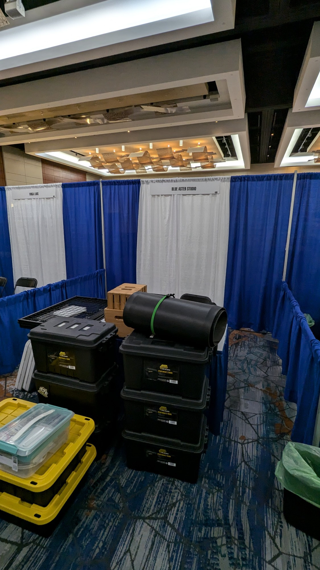 An empty conference exhibit booth with big totes to unpack 