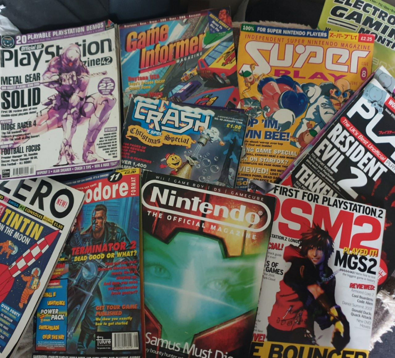 A photo of old magazines including Crash, Zero, Game Informer, PLAY, OPMUK, and Super Play. 