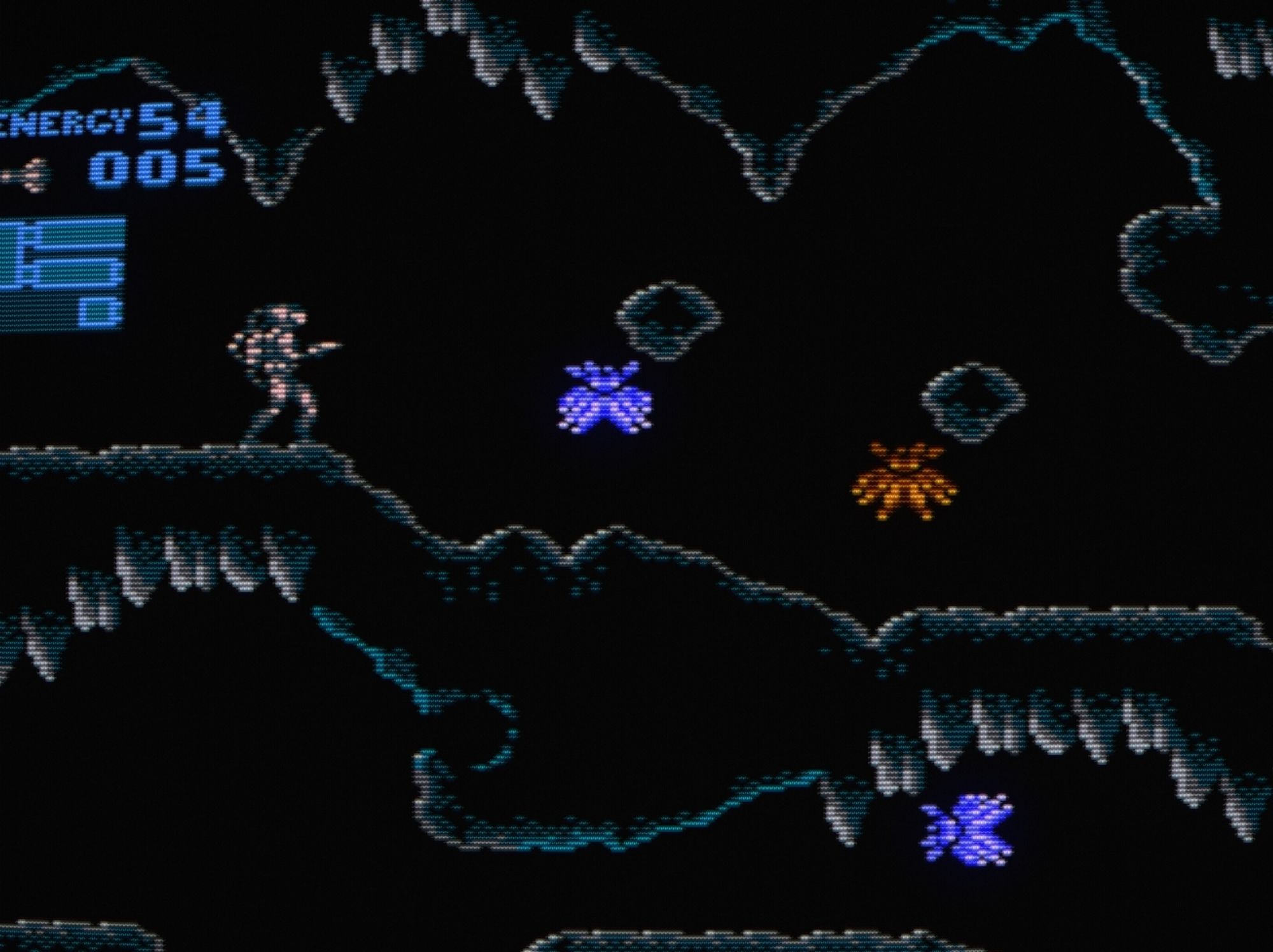 A close-up of Samus's initial cavern delving wearing a darker-toned and more industrial-looking power suit that has vibes of a divers or rugged space suit.