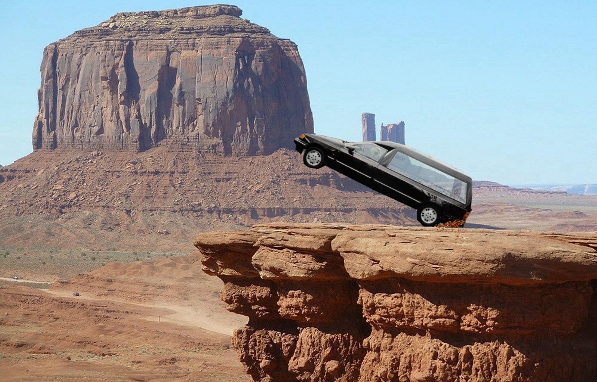 Somewhere in Monument Valley, a young lad drives a hearse.  It is rearing up on its hind wheels, sparks spraying behind it as it revs to the rescue