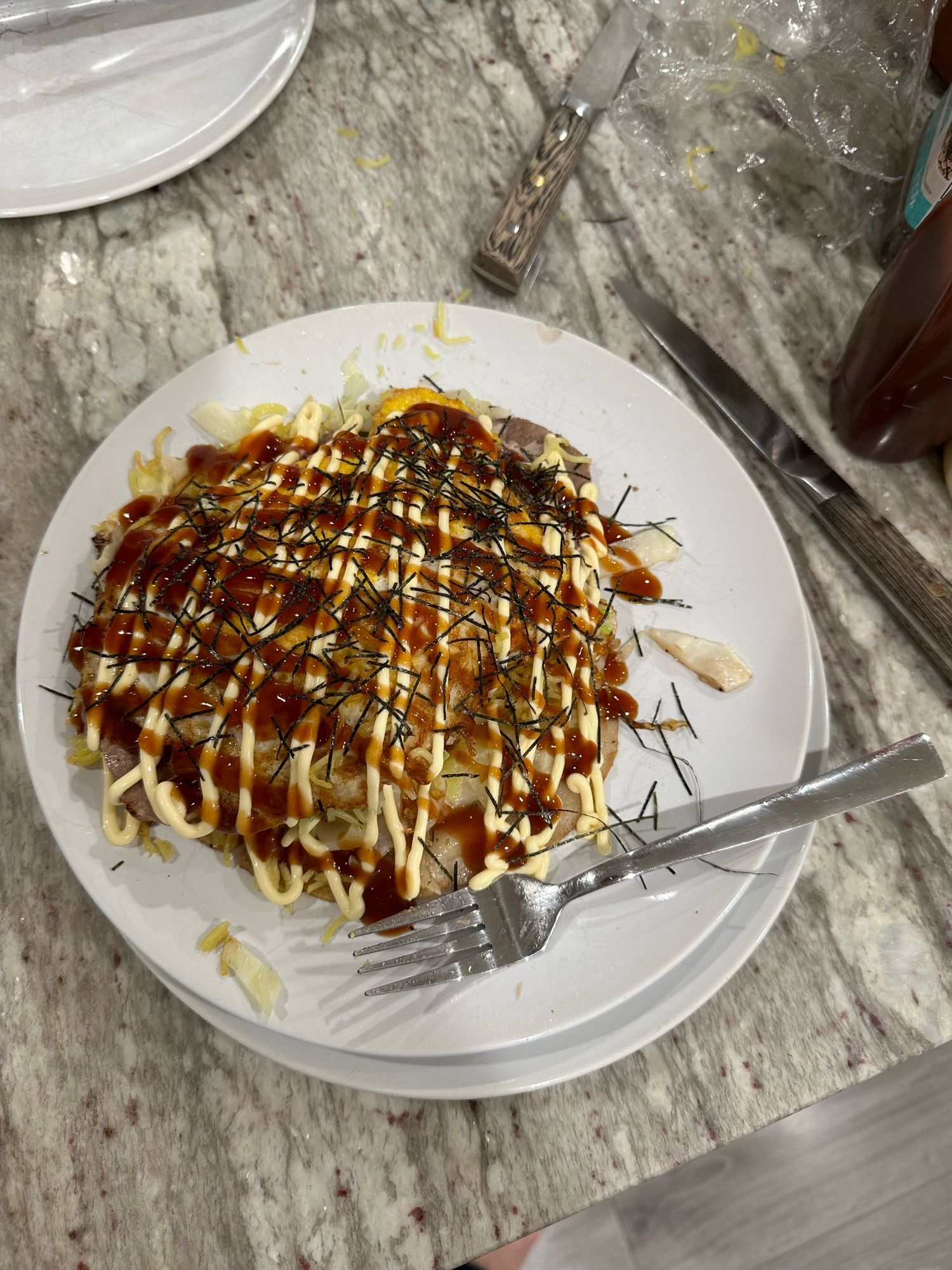 Plate of okonomiyaki; pancake covered in kewpie, Okonomiyaki sauce and Aonori