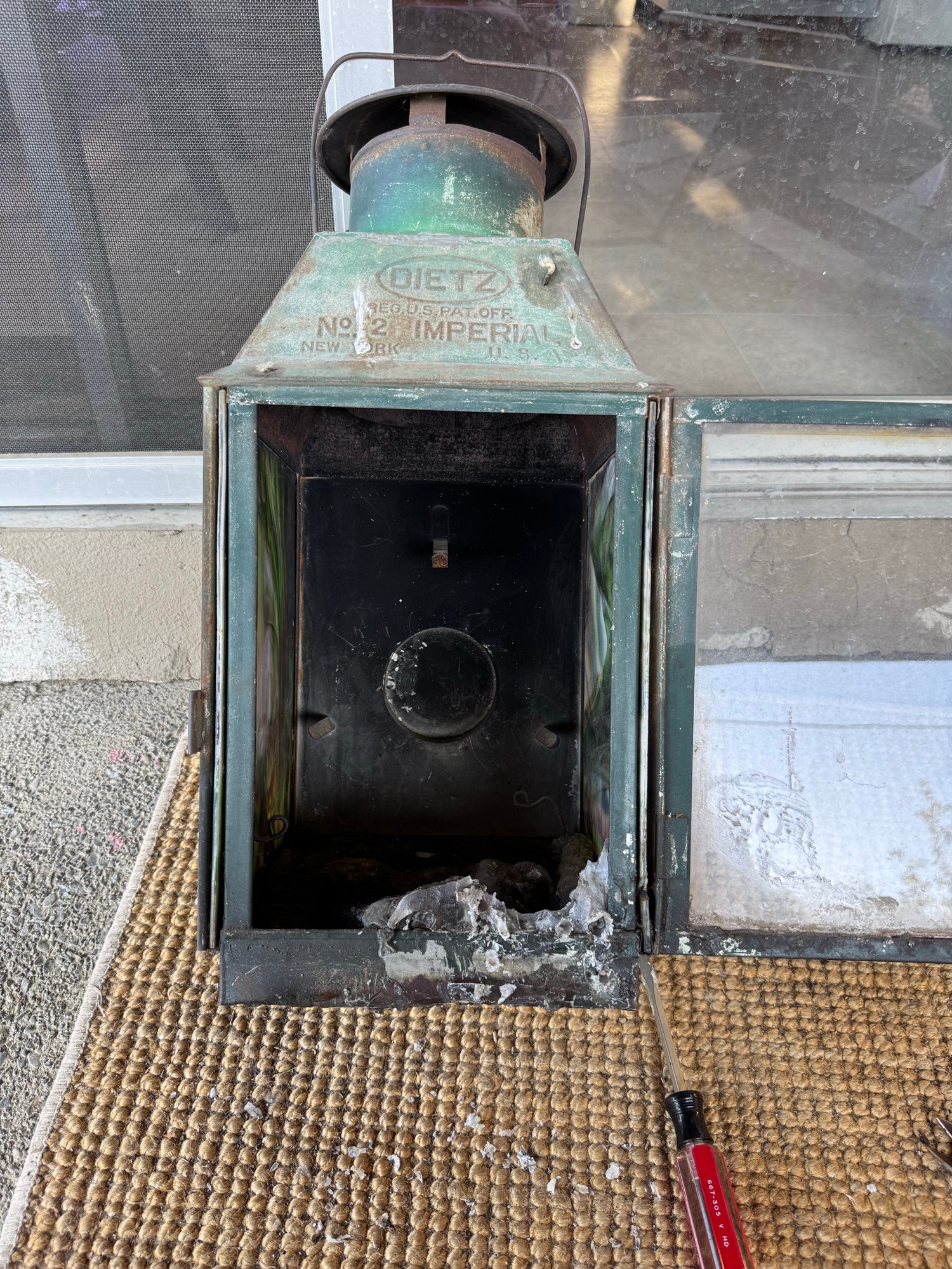 Old railroad station lantern filled with very old candle wax