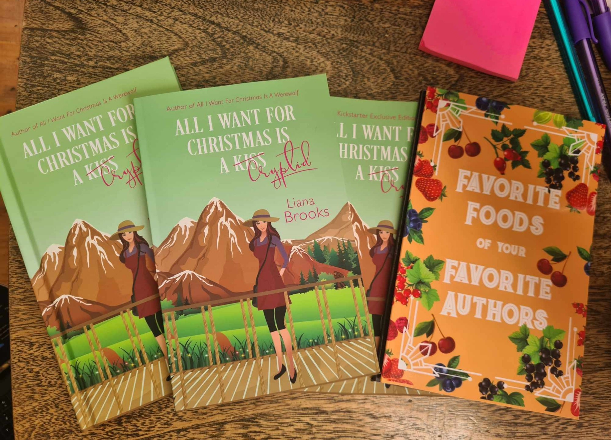 Hard copy and paperbacks of ALL I WANT FOR CHRISTMAS IS A CRYPTID and an orange book that is the recipe book