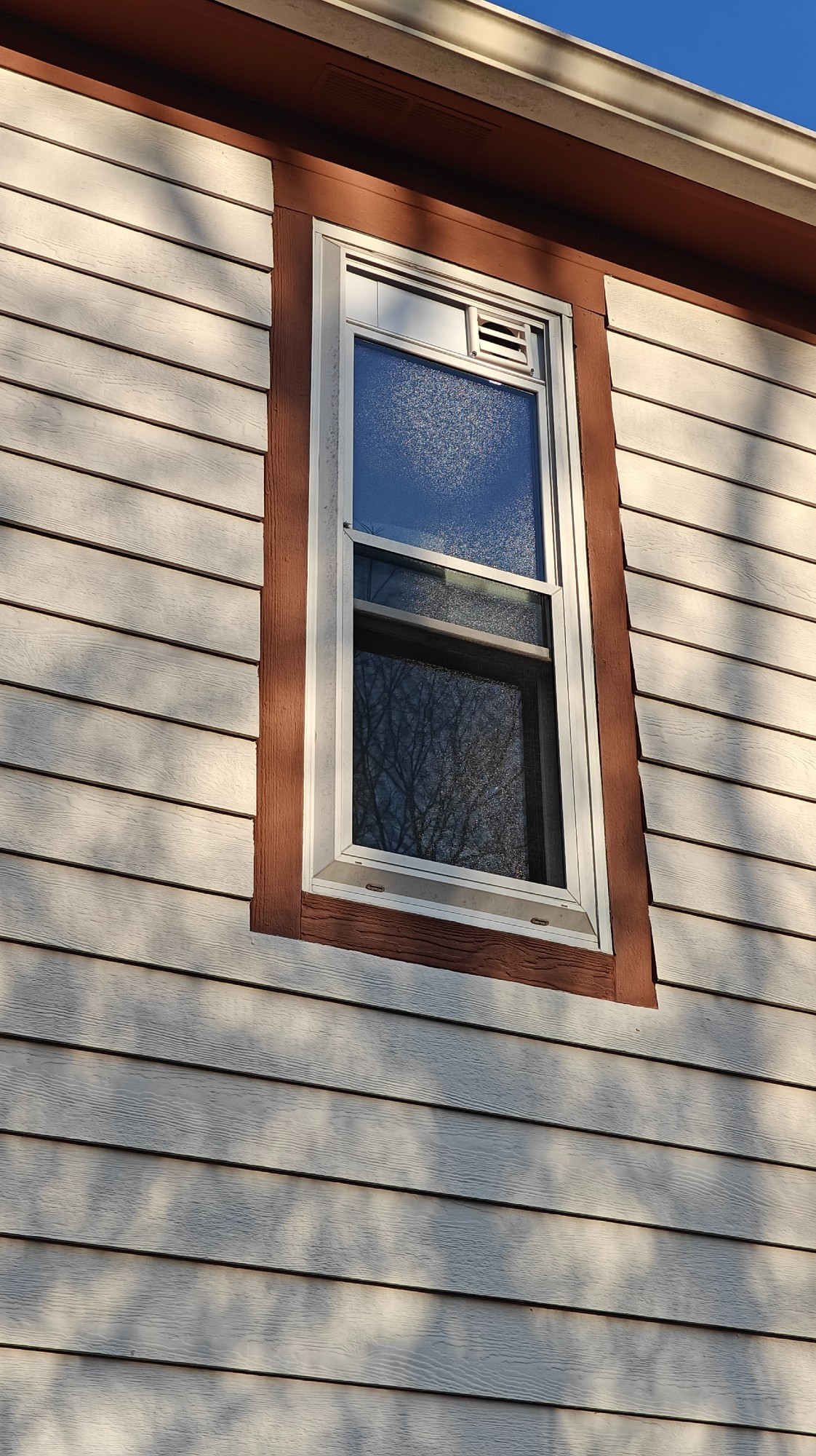 view of the window from the outside showing the standard drier duct work being used