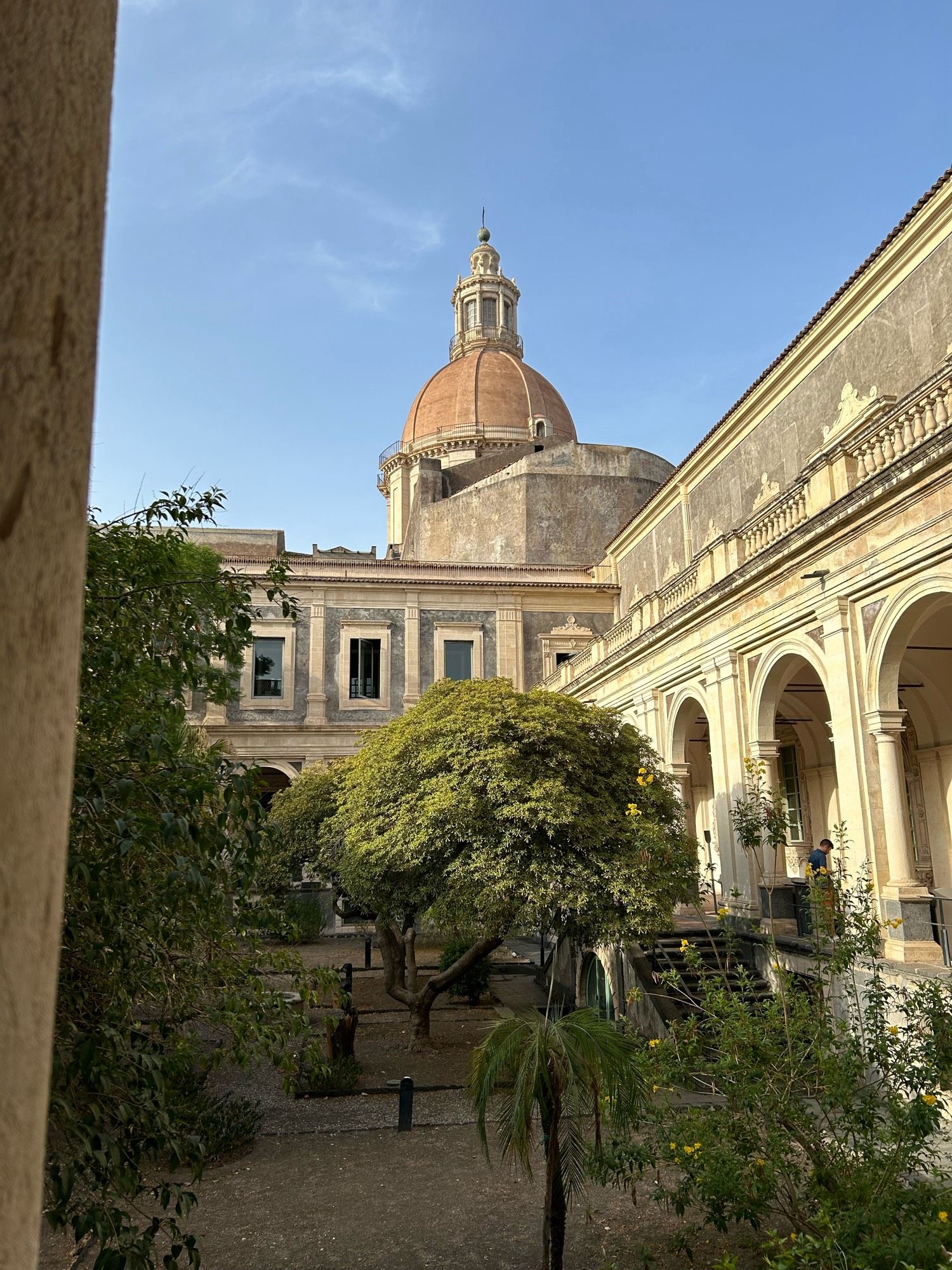 Looking up to the dome of a monastery from a courtyard/atrium.