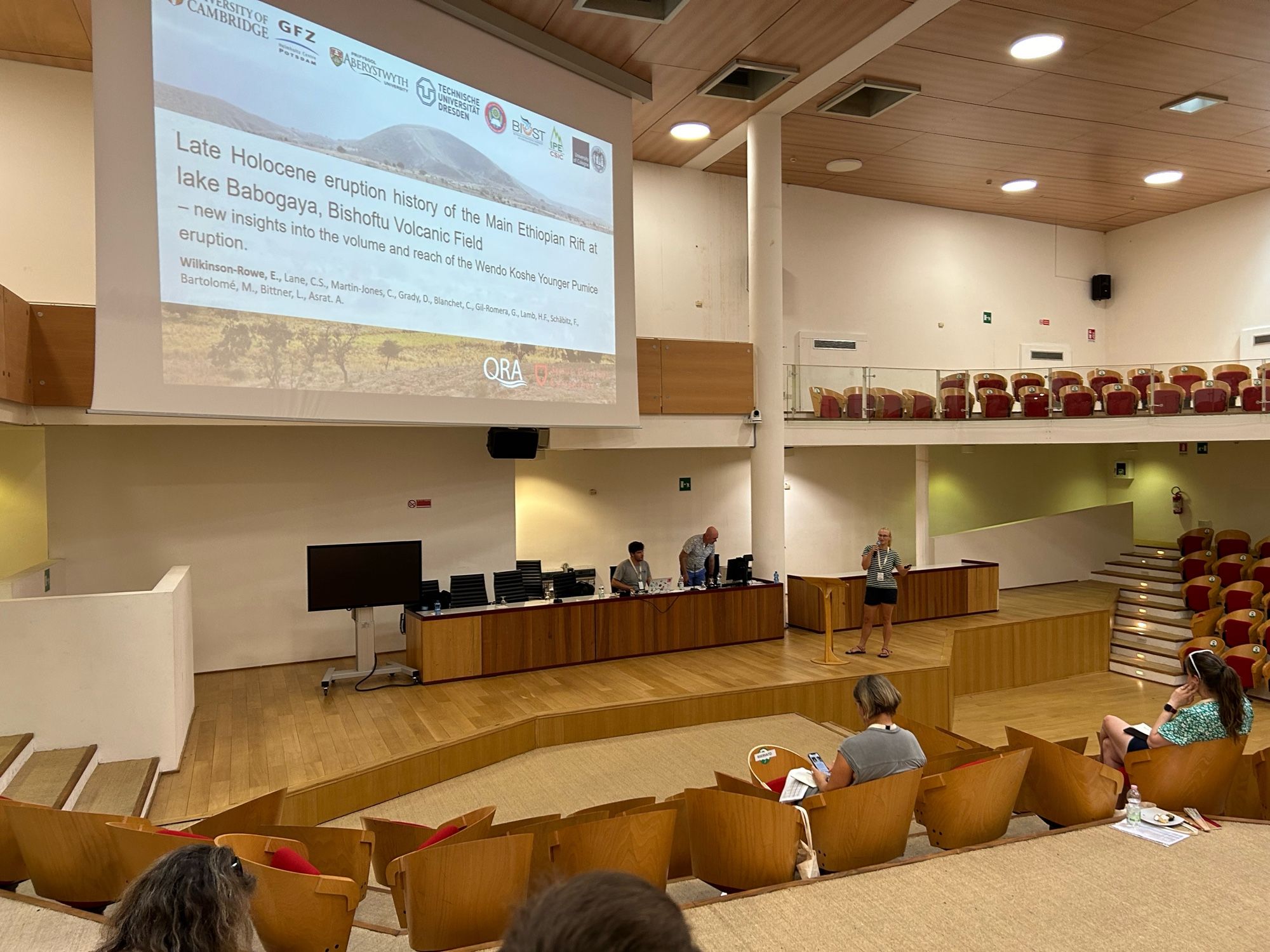 A scientist presenting in an auditorium