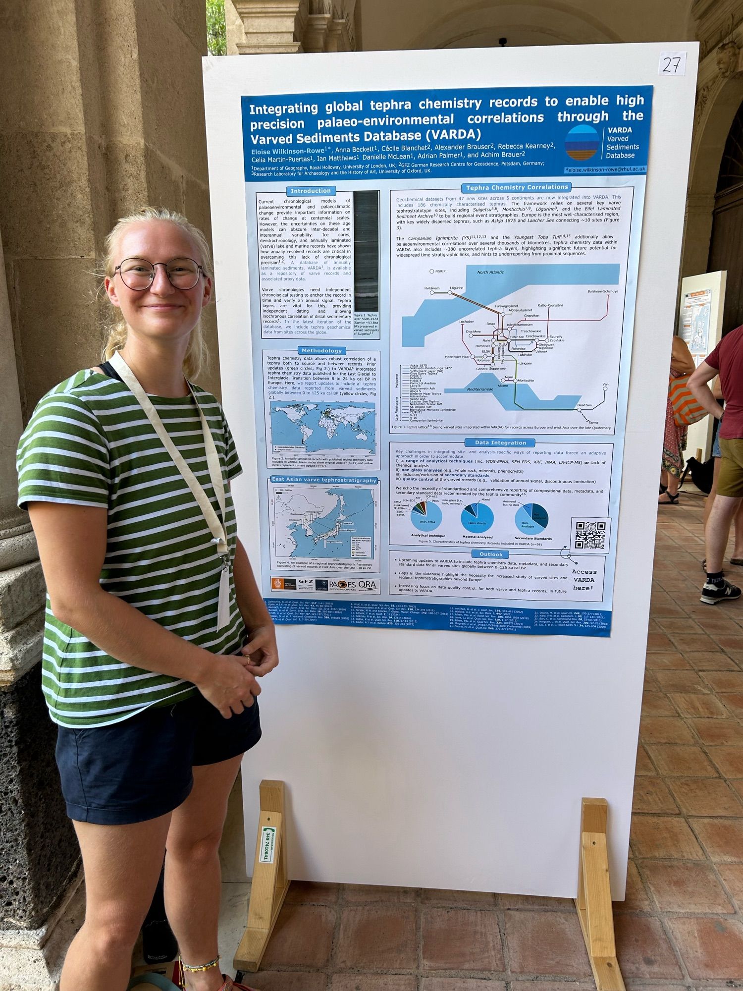 A scientist stood by a poster board at a conference