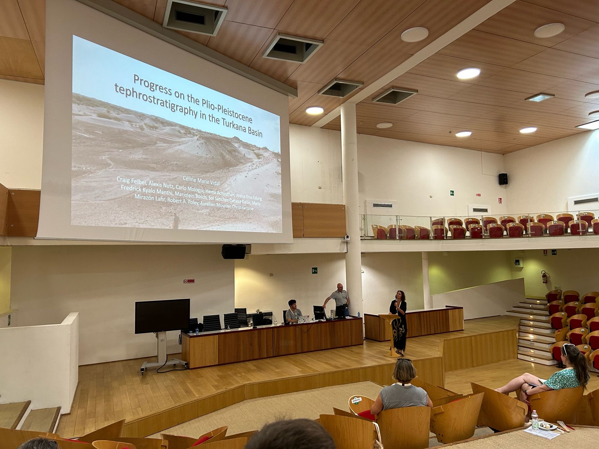 A scientist presenting in an auditorium