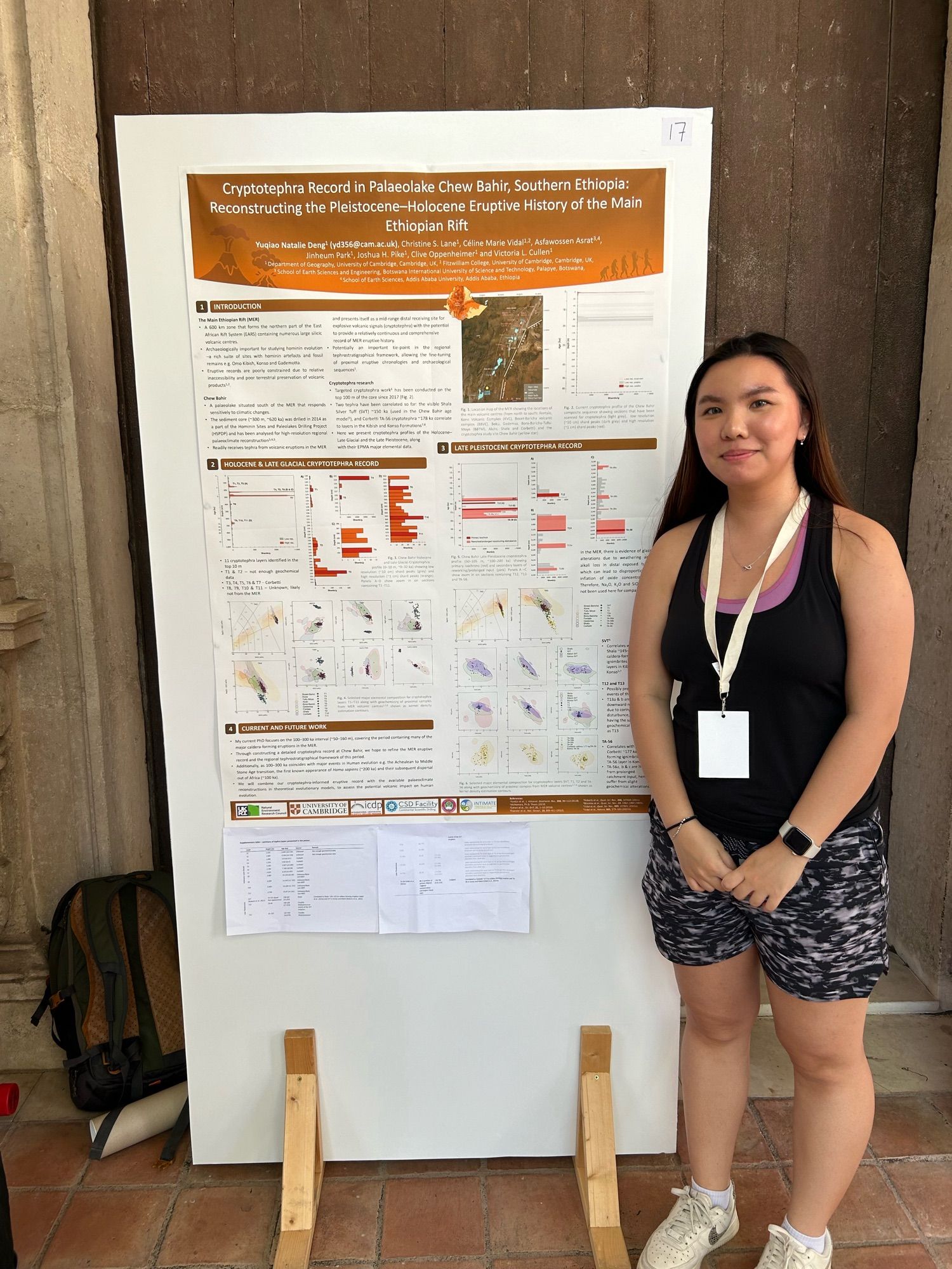 A scientist stood by a poster board at a conference