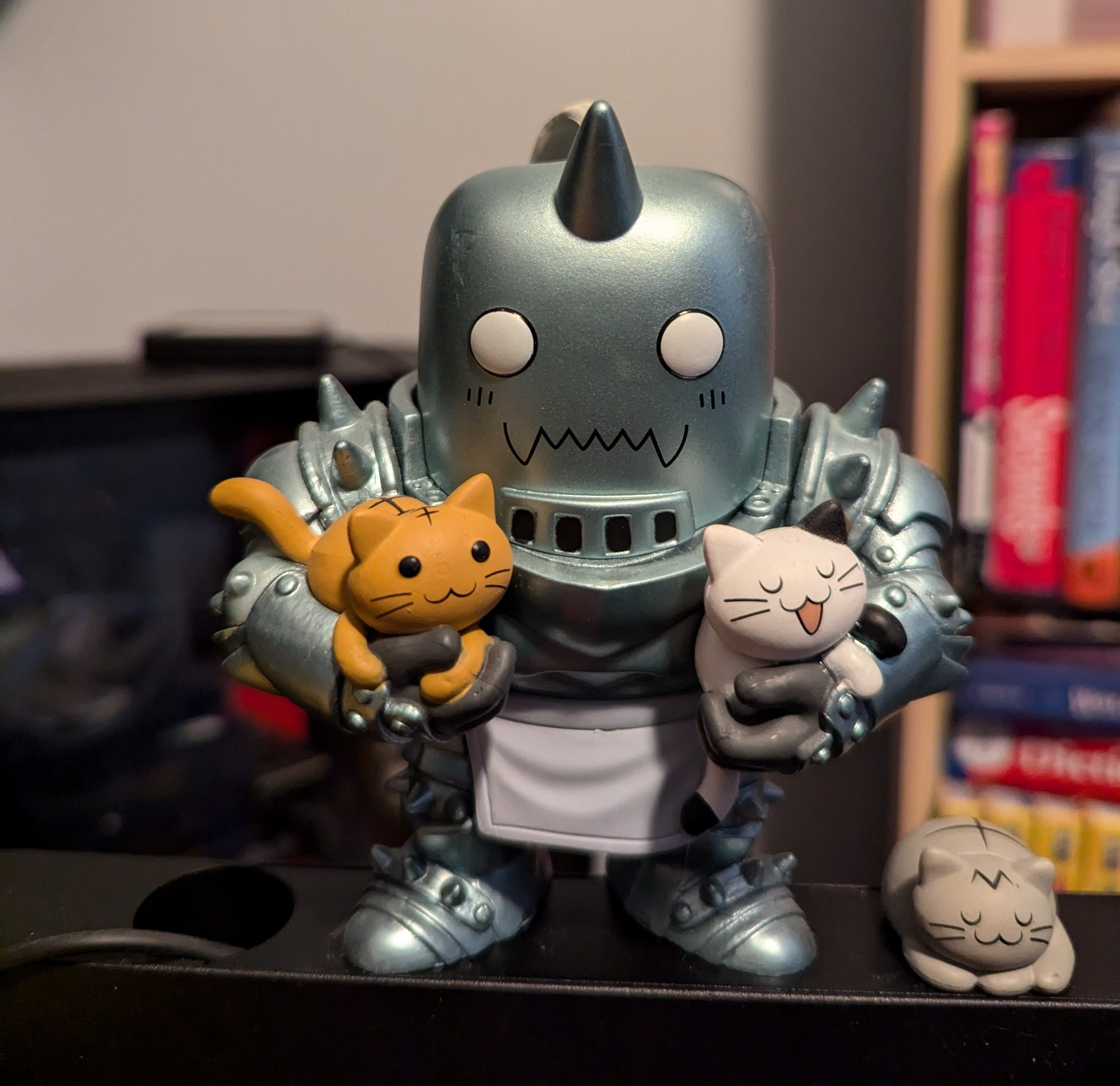 Alphonse Elric from Full Metal Alchemist as a pop vinyl figurine, carrying 2 cats with one beside the figure, standing on my mic arm