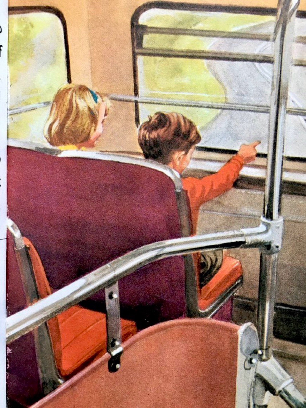 Two children sit in the very front seat of a double-decker bus. The boy is pointing excitedly out of the window.