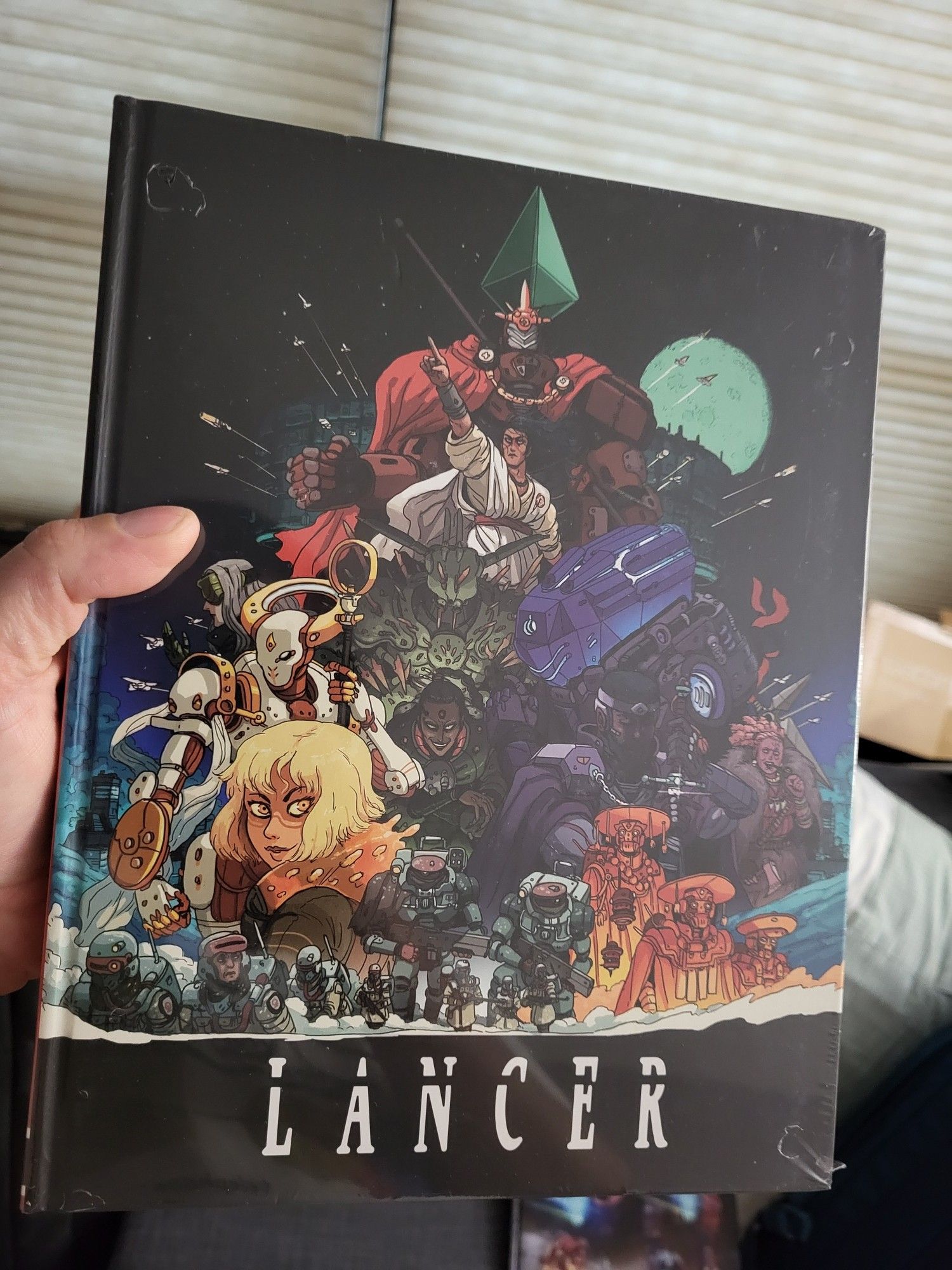 A hard cover copy of the rulebook for the Lancer mech RPG