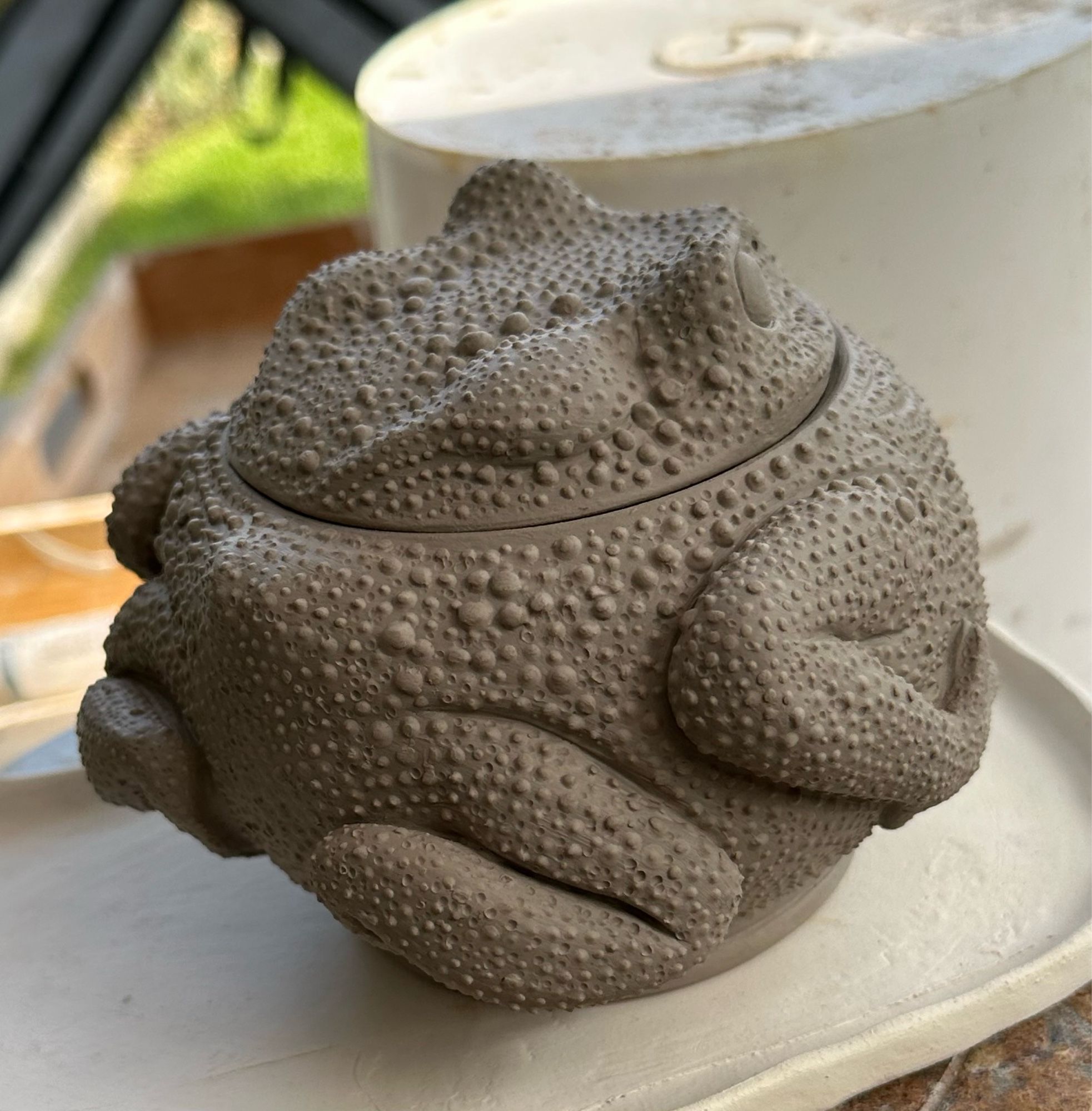 Unfinished ceramic lidded pot in the shape of a round toad