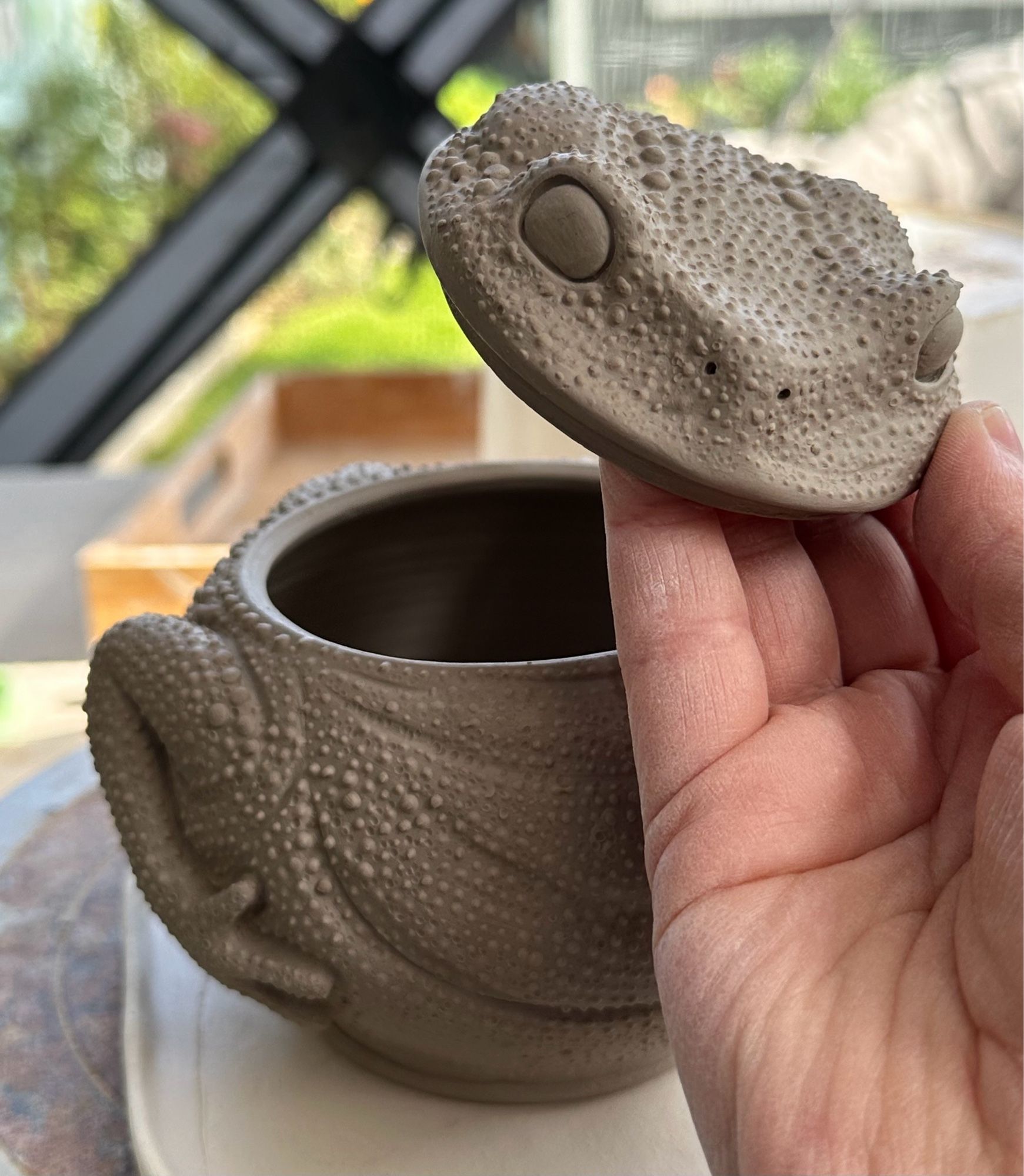 Unfinished ceramic lidded pot in the shape of a round toad