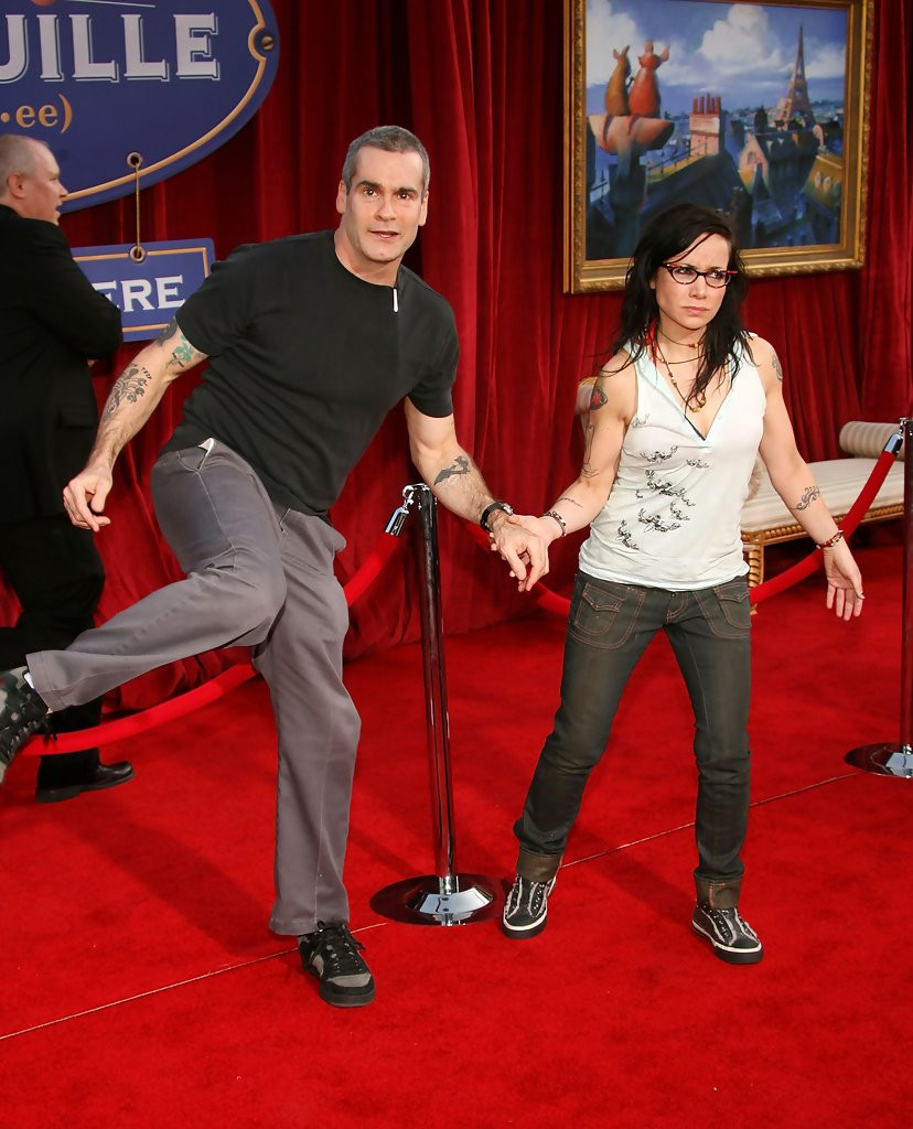 Janeane Garofalo helping Henry Rollins step over a movie theater line rope at the premiere of Ratatouille.

Henry Rollins looks particularly amused.