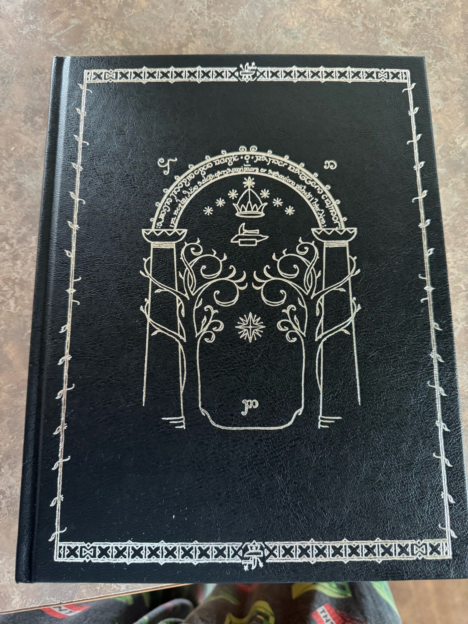 The all black cover with the magic elven runes of the door into Moria.