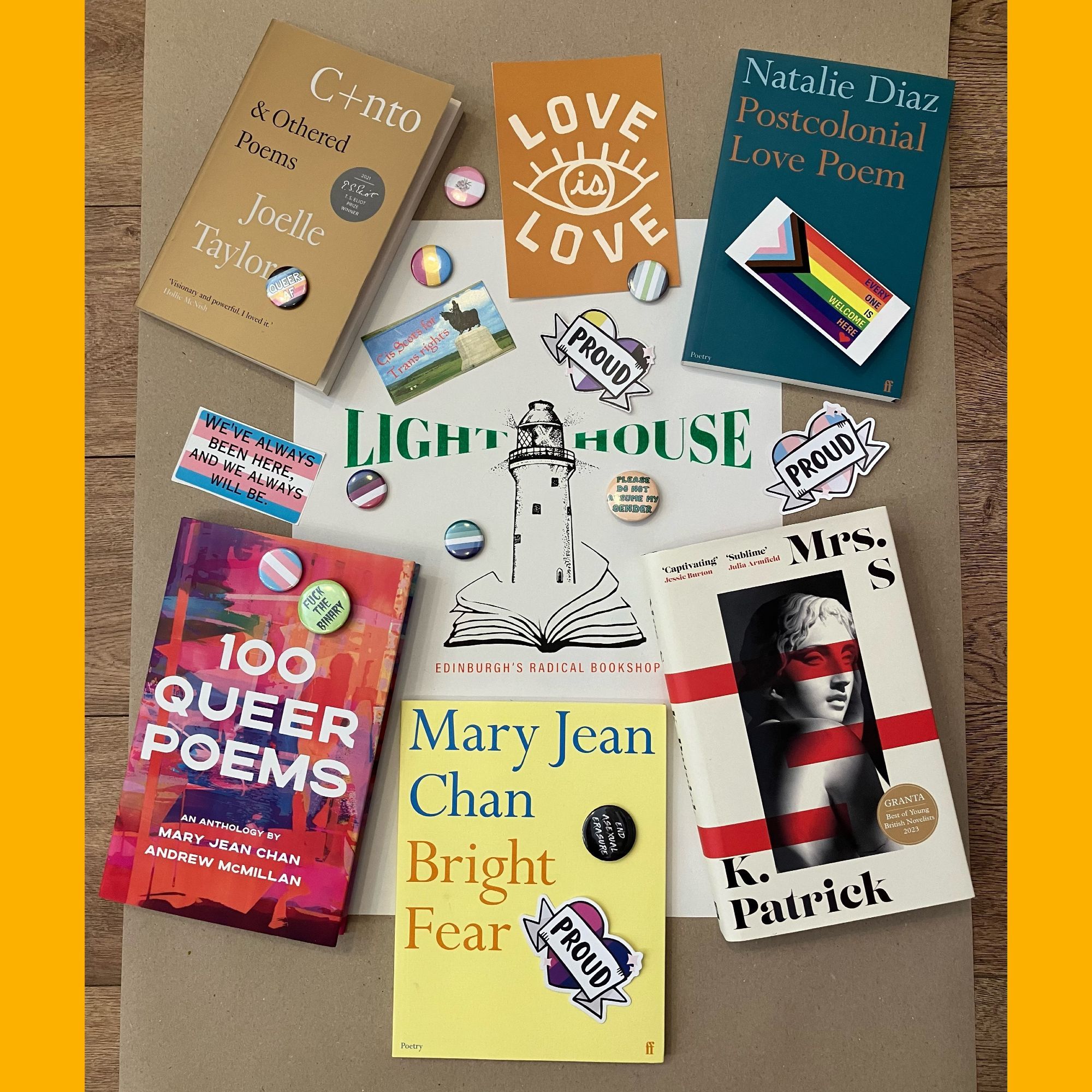 A display of books, LGBTQ badges, stickers and postcards laid out on a piece of brown wrapping paper. The books are by Joelle Taylor, Natalie Diaz, Mary jean Chan and K. Patrick as well as the anthology 100 queer poems. In the middle is a Lighthouse bookshop poster.