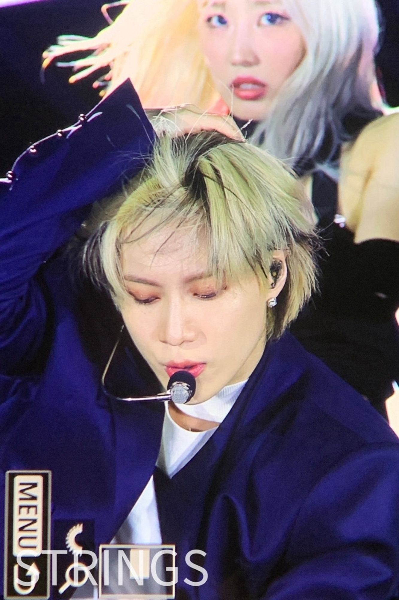 Taemin pushing his hair off his forehead thru different eras. He has blonde hair here.