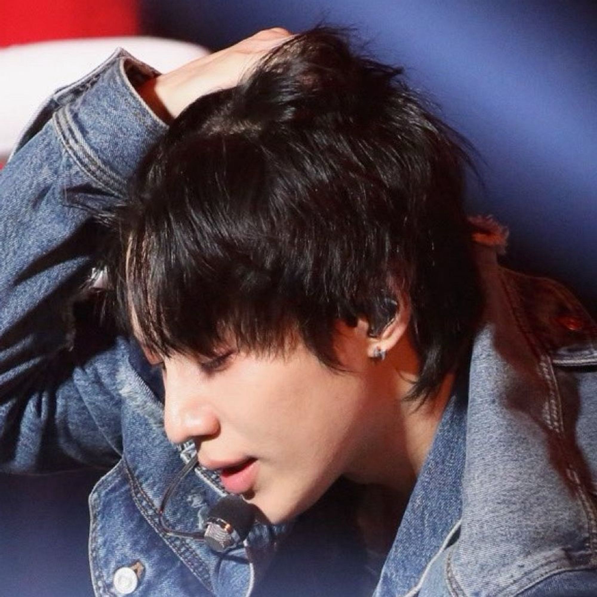 Taemin pushing his hair off his forehead thru different eras. He has black hair here and it is a side view.