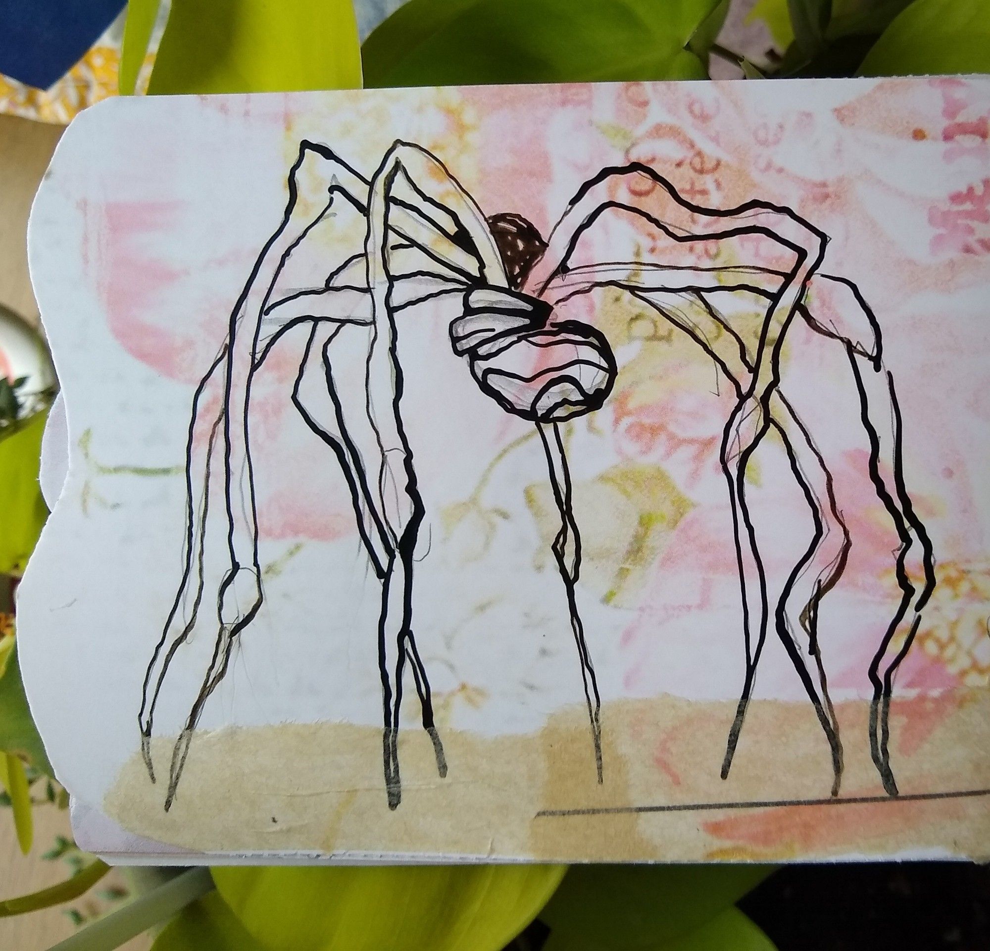 A sketch of a spider sculpture, done with deep brown ink on paper with a soft floral print in pink and light green.