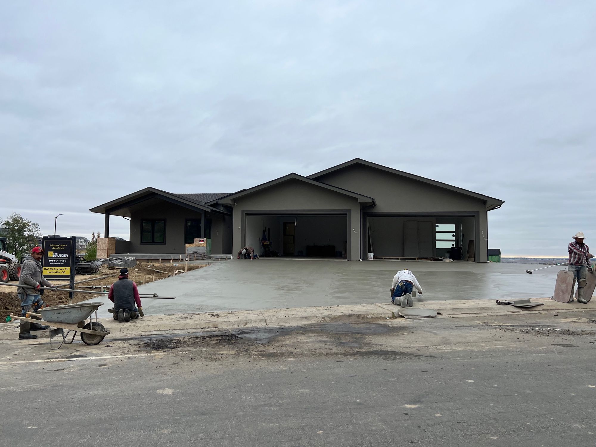 Massive four car garage building with small shed for humans in the side.