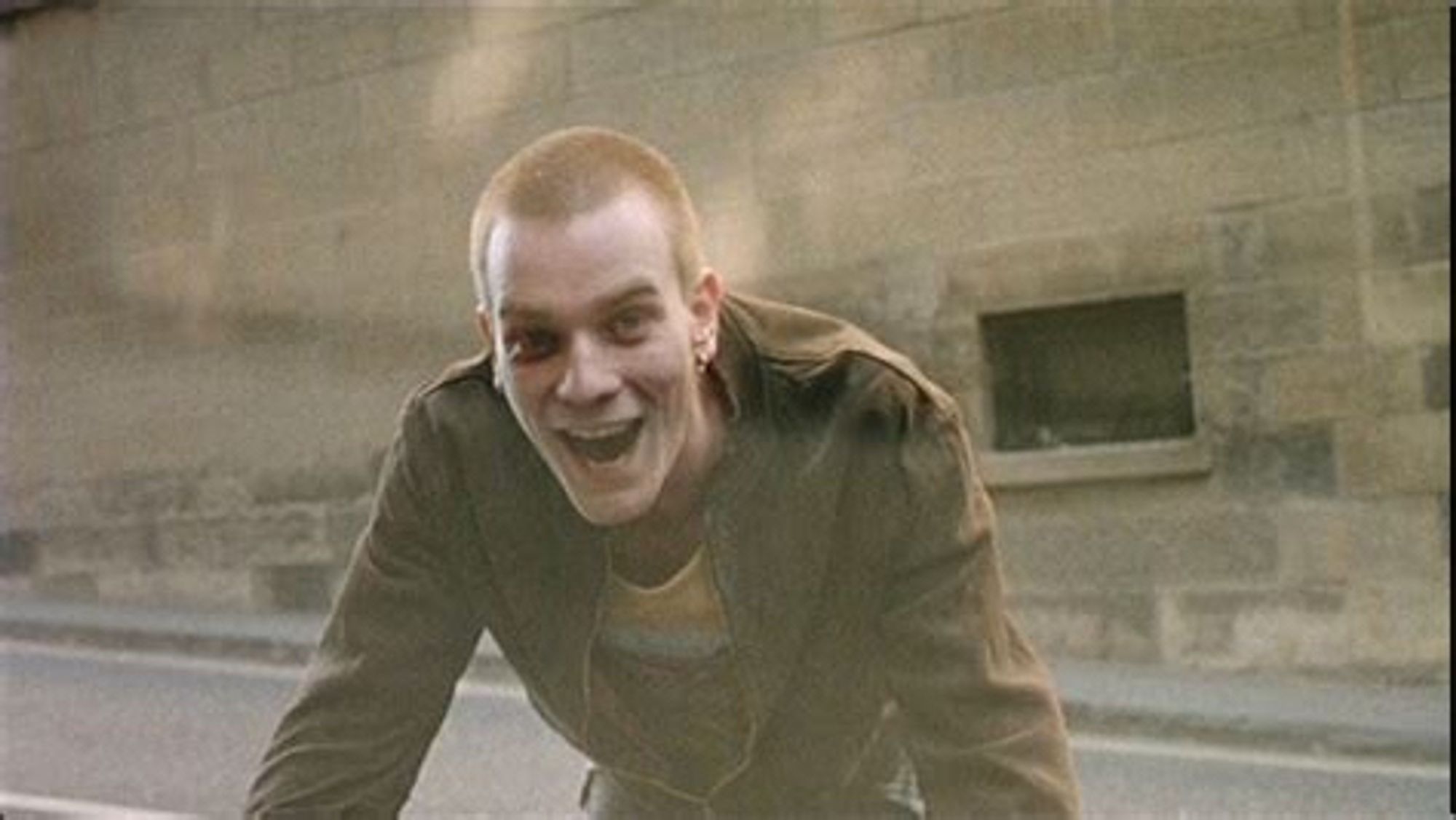 Iconic film scene of Mark Renton in “Trainspotting”, who had a moment before been quickly running down a street in Edinburgh city centre, suddenly forced to an abrupt halt as a car pulls out unexpectedly from a side alley.