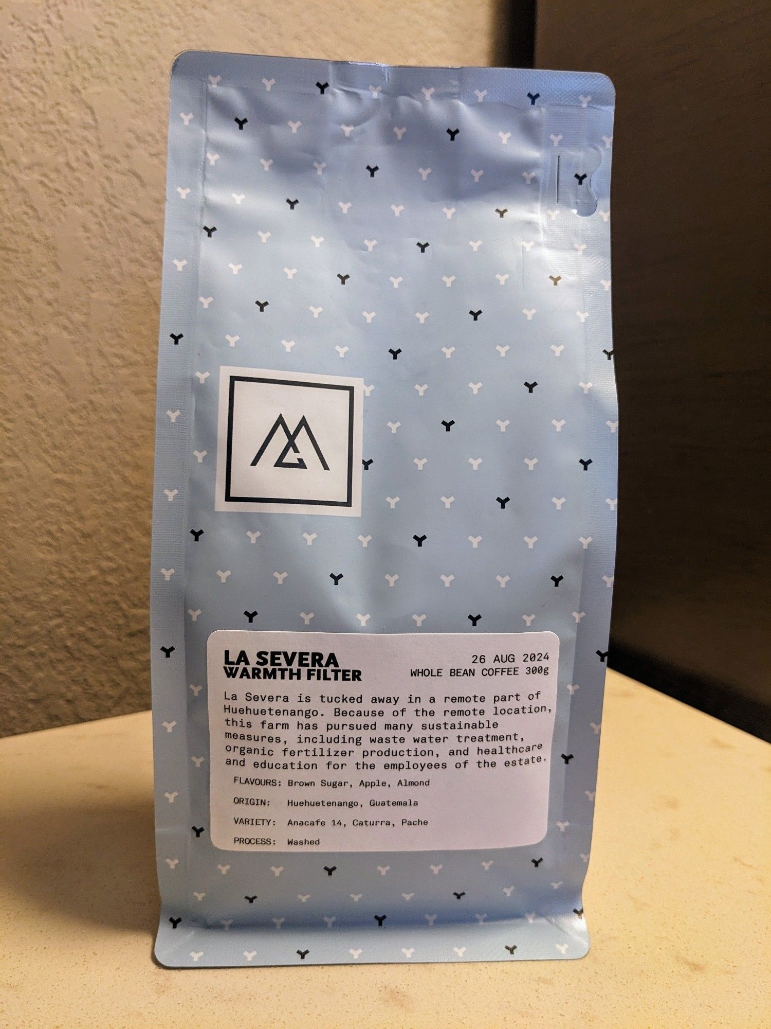 A bag of roasted coffee beans from Monogram Coffee in Calgary, AB. The coffee is a washed single-origin from Huehuetenango, Guatemala, with tasting notes of brown sugar, apple, and almond. 

It was purchased from Hide & Seek Coffee, a multi-roaster shop in Victoria, BC.