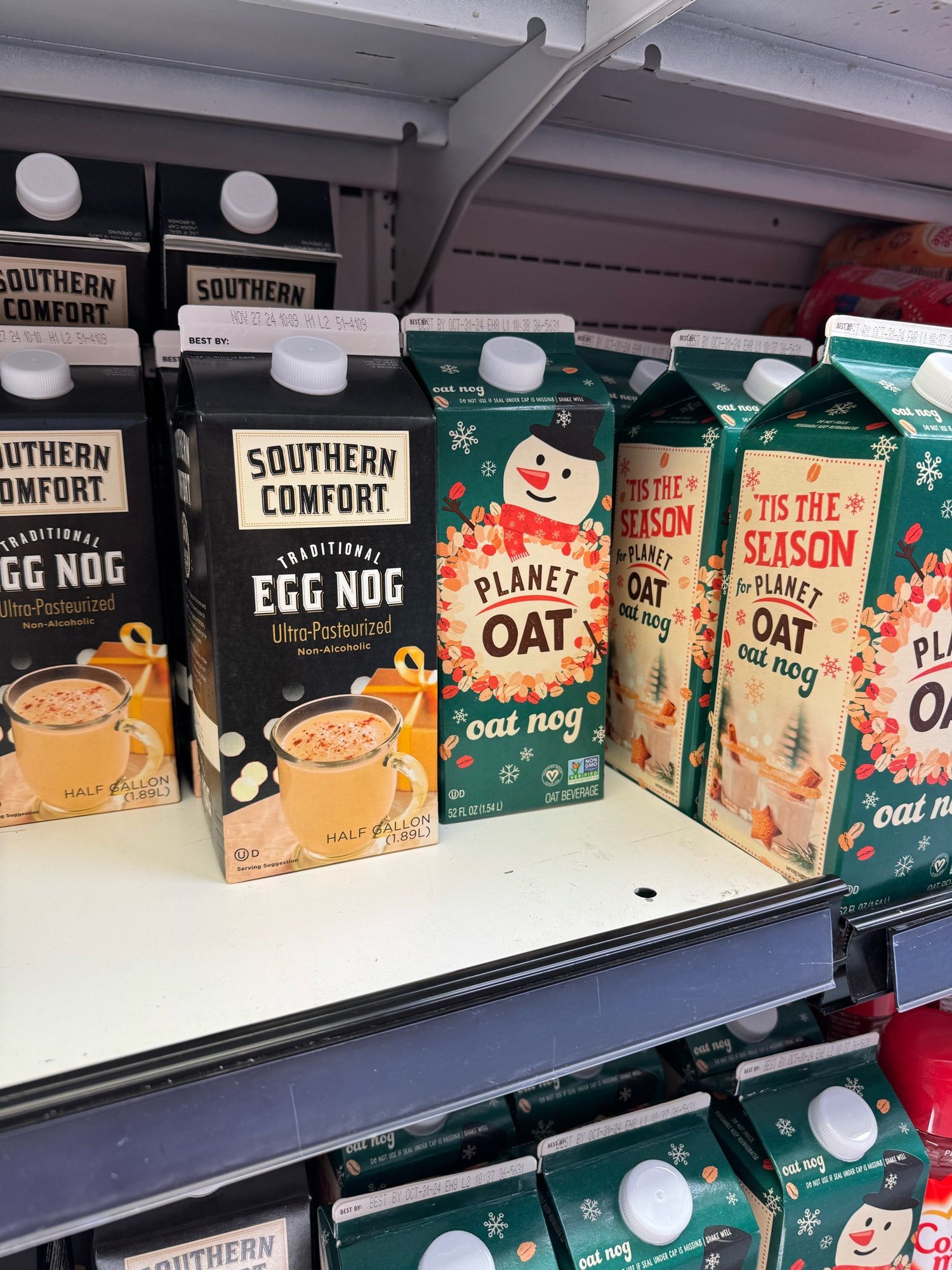 Egg nog on a shelf at the grocery store. The oat nog carton says “tis the season.” The season is apparently in September.