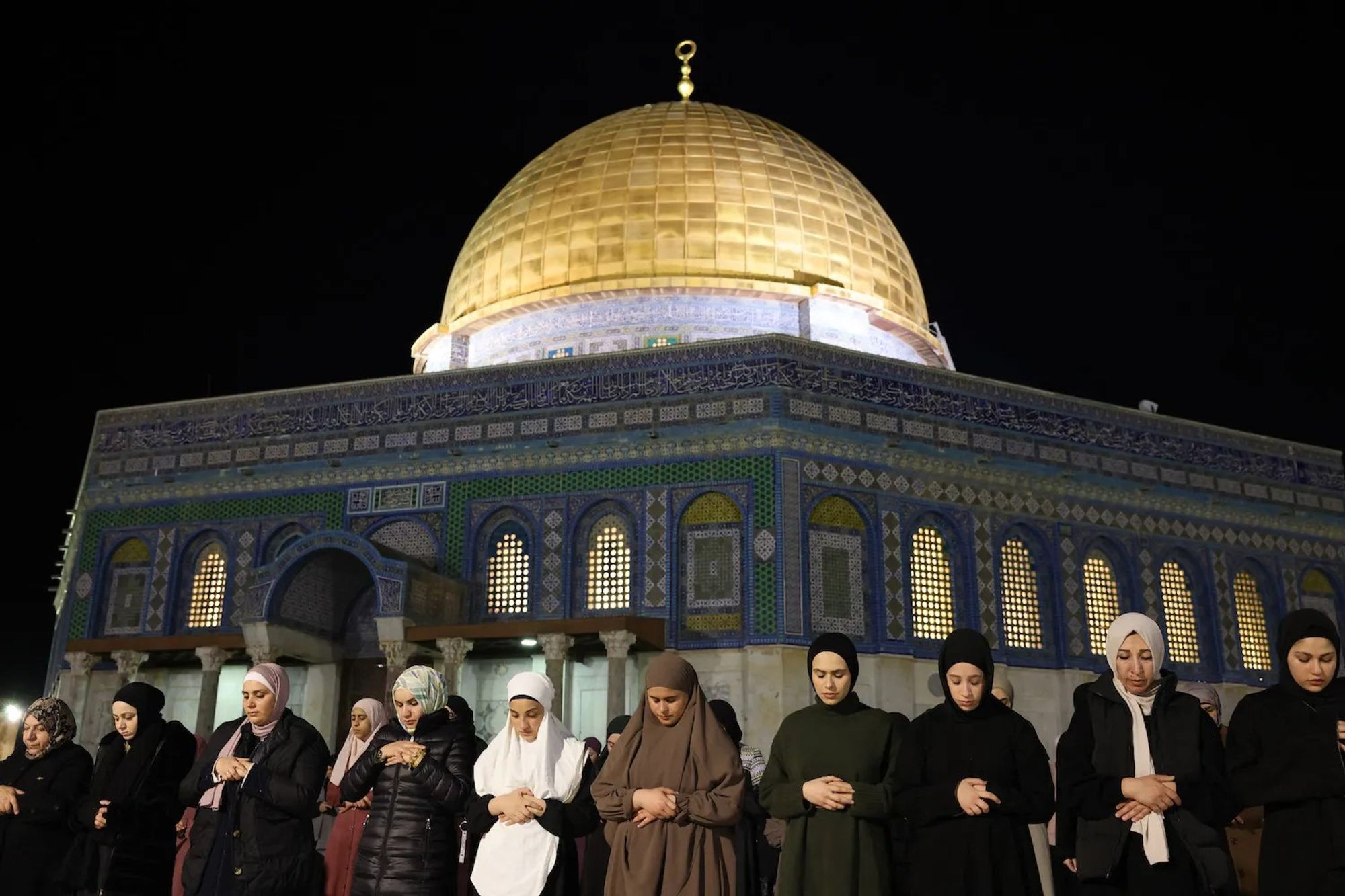 photo: "Palestinian Muslim devotees perform evening prayers known as the Tarawih outside the Dome of the Rock in Jerusalem's Al-Aqsa Mosque during the holy month of Ramadan on March 11 (Ahmad Gharabli/AFP via Getty Images)