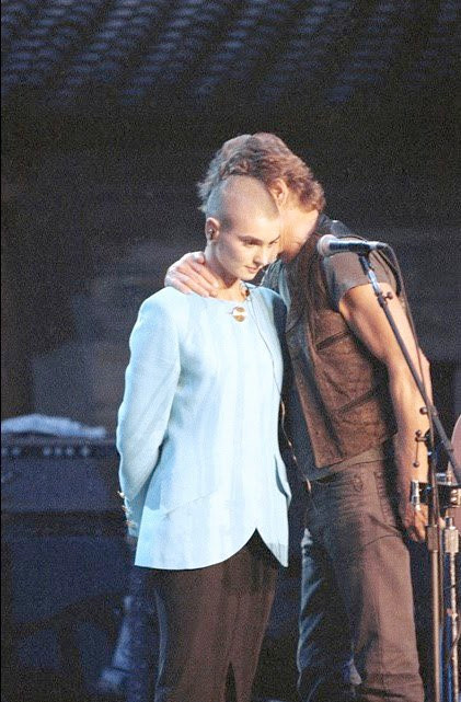 (1992) Kris Kristoferson comforting Shuhada Sadaqat (born Sinéad O'Connor) on stage at Madison Square Garden during the 30th anniversary tribute concert for Bob Dylan, after the audience booed her over her SNL protest of the Catholic Church and its abuses of children and marginalized people.