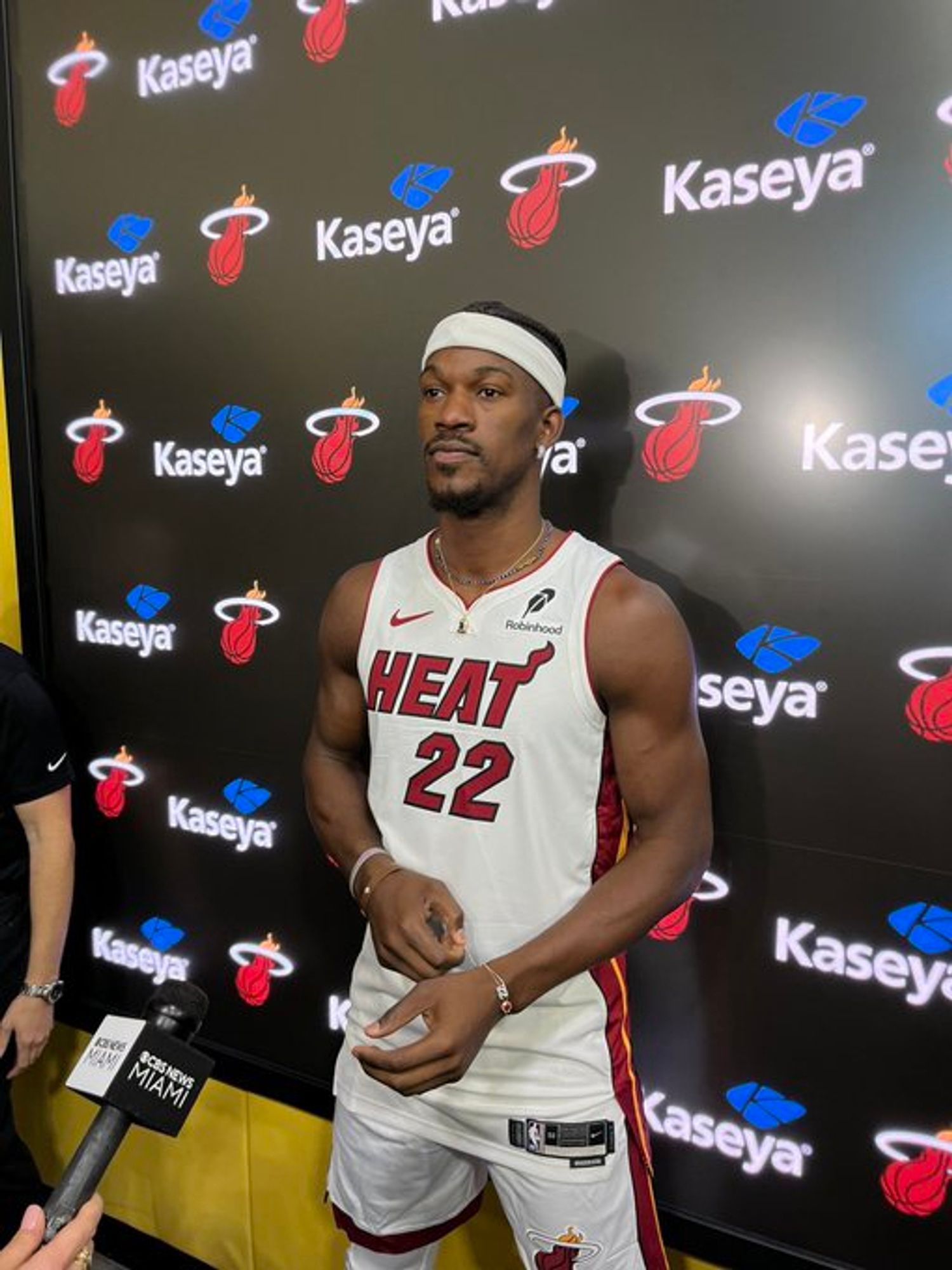 Jimmy Butler looking sad that he doesn't get to wear a costume or wacky hair this year during media day while wearing his white Miami Heat costume.