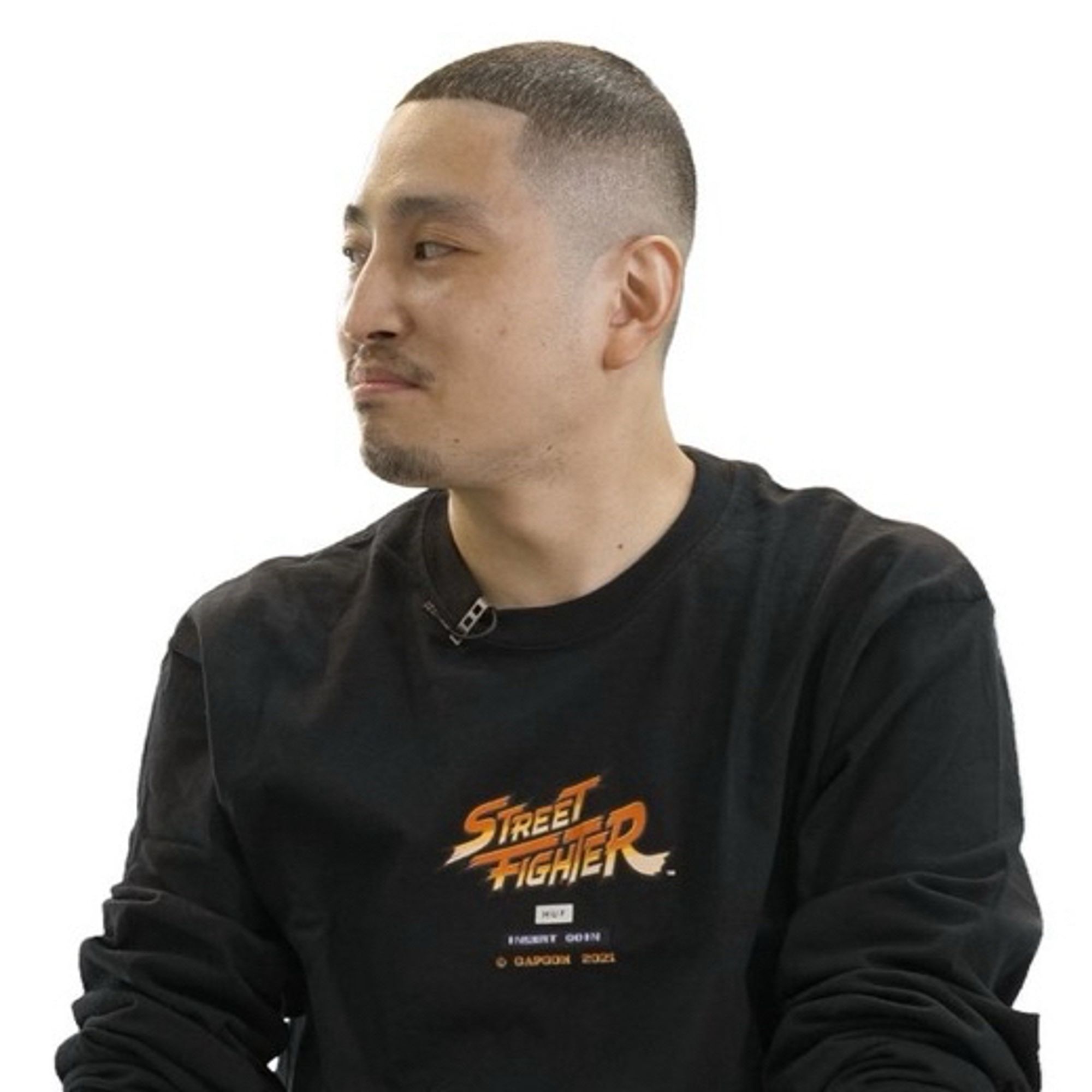 Shuhei Matsumoto, co-producer of Street Fighter 6, looking to his right with a confident expression in a black sweater