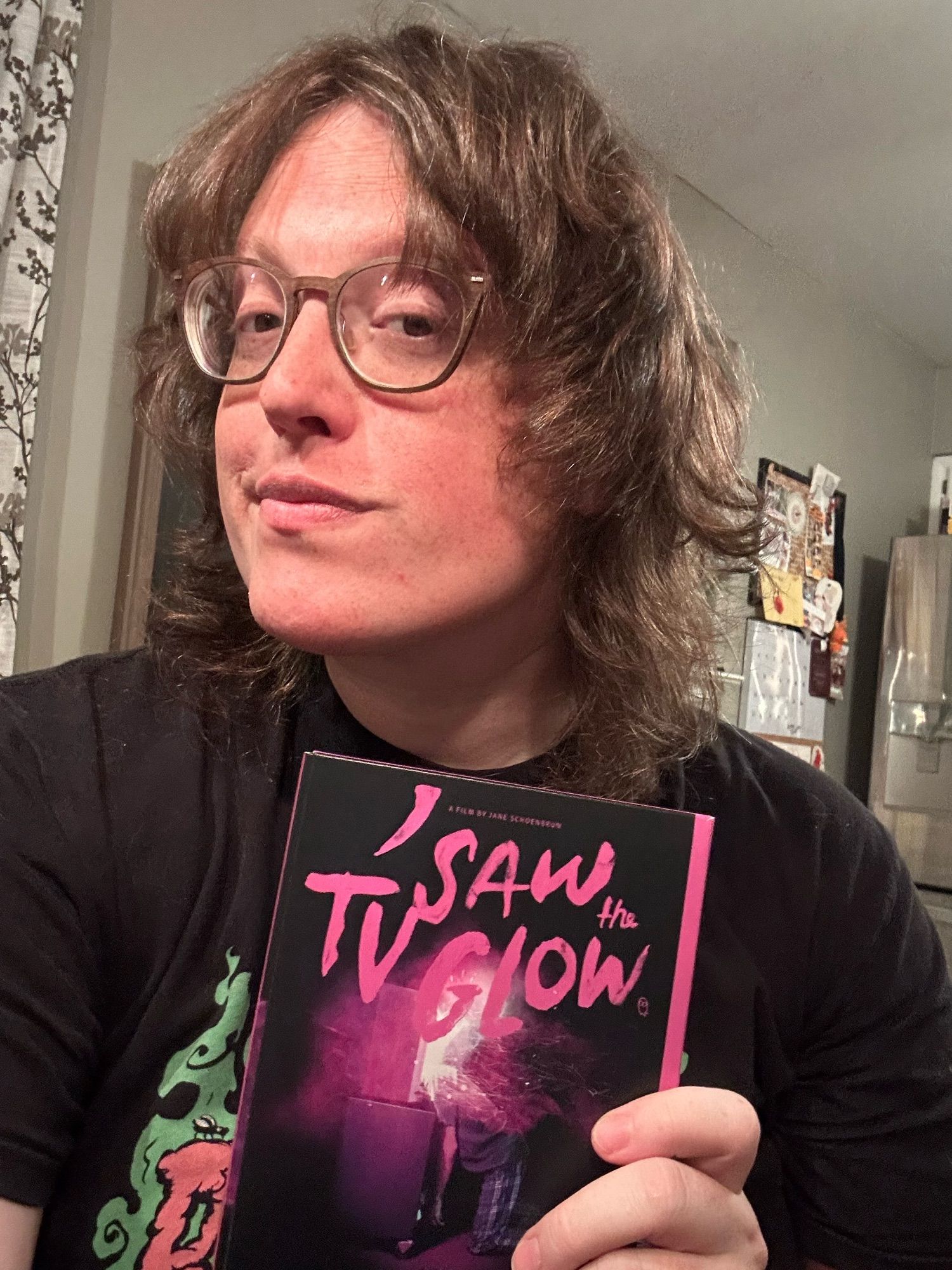 Emma posing with a copy of I Saw the TV Glow for some reason.