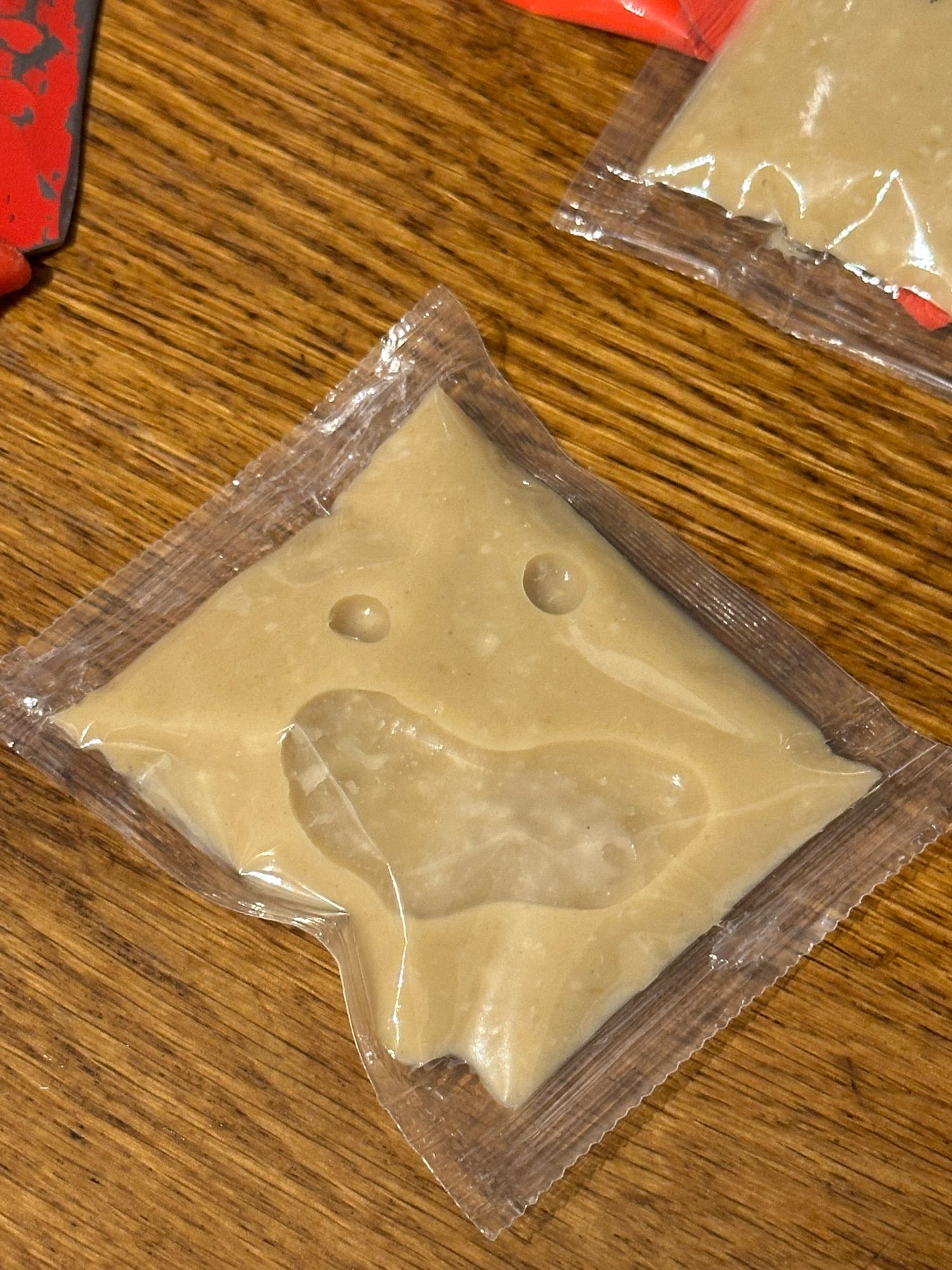 A picture of a packet of garlic puree that resembles a screaming face.