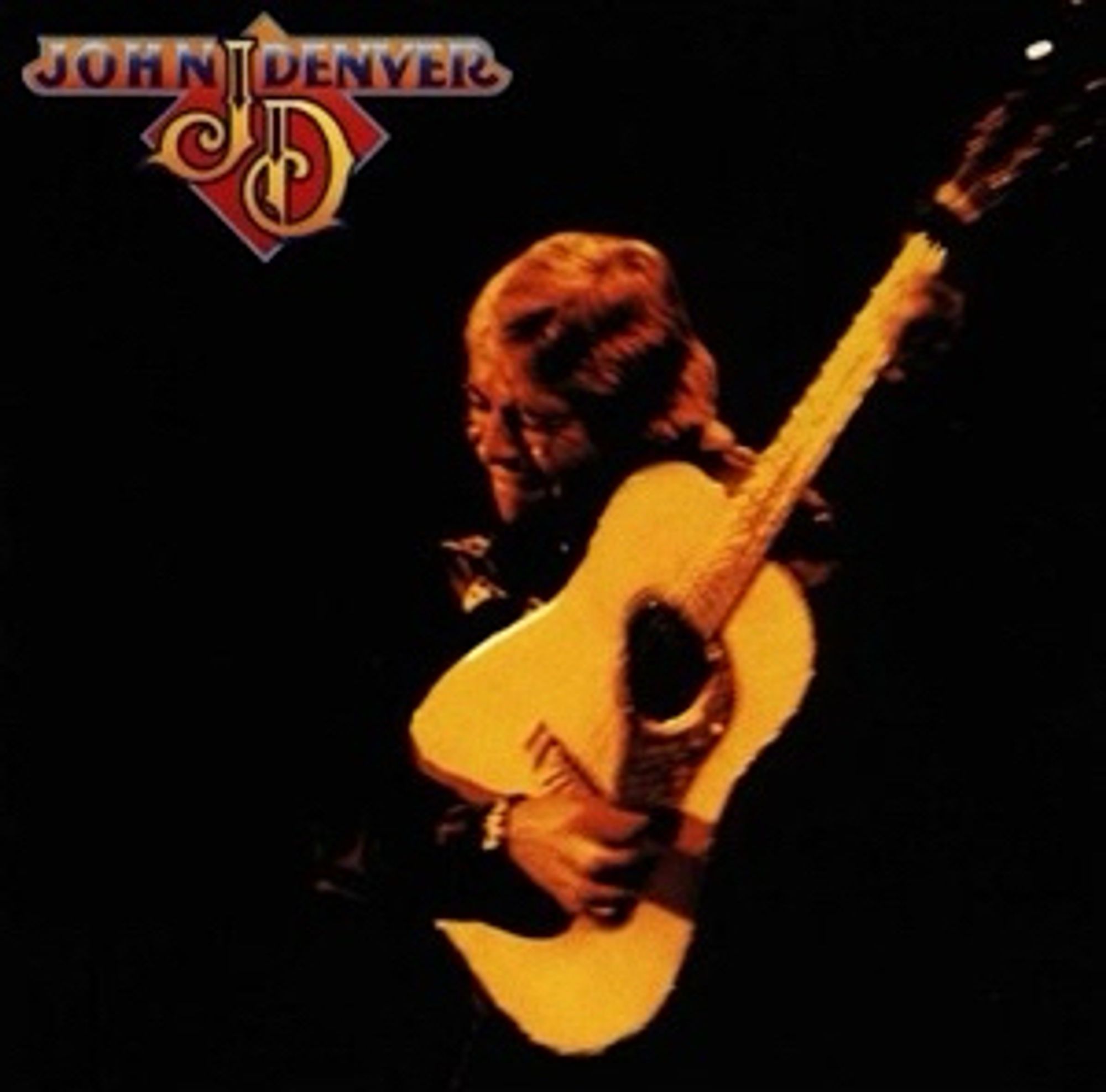 The cover of John Denver, the thirteenth studio album by American singer-songwriter John Denver, released in January 1979. John is on stage, jet black background, acoustic guitar raised diagonally in a pose eerily prescient of today’s Instagramable aspect ratios. It’s a blurry shot and we suspect the photographer has been fully enjoying the late 70s. John’s refused to pay full price and haggled a bargain. Not his first rodeo. John has an anguished look on his face. The rigours of the country road obvious. He’s aging. You can’t go on surviving on white bread and Chipsticks your whole life, John. Try some soluble fibre like fresh fruit and veg, oats for breakfast, beans, lentils, pulses, that’ll help. Get yourself a Delia Smith and learn how to cook an egg, for goodness’ sake. Follow Fanny Cradock.