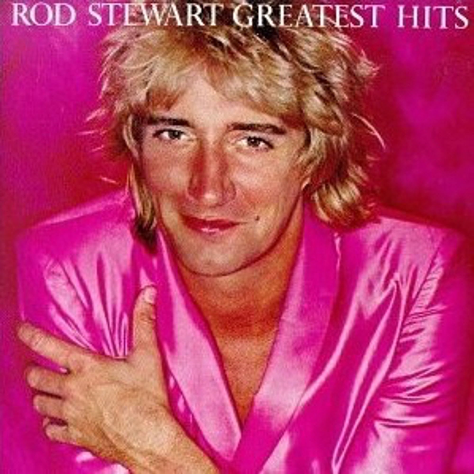 The cover of Greatest Hits, Vol. 1, Rod Stewart's 1979 best-of compilation. Rod is wearing a hot pink shiny jacket, no shirt, no wedding ring. Satin or silk? Probably silk - he’s done ok for himself. His glorious blonde hair is lightly shagged and we doubt the cuffs match. Rod’s caught the sun - clearly he hasn’t been on holiday with Australians - no constant bollockings to use sunblock for him. A smile says Rod just bashed out another top 10 hit about birds in time for the start of the football, honey. His legs are out of frame but we know they’re covered in more leopard print than a soap opera landlady. He’s still thin enough to squeeze into a child-size tracksuit to save paying VAT. The tracksuit is now vintage and worth more than all his records. It’s good to have a diversified pension plan.