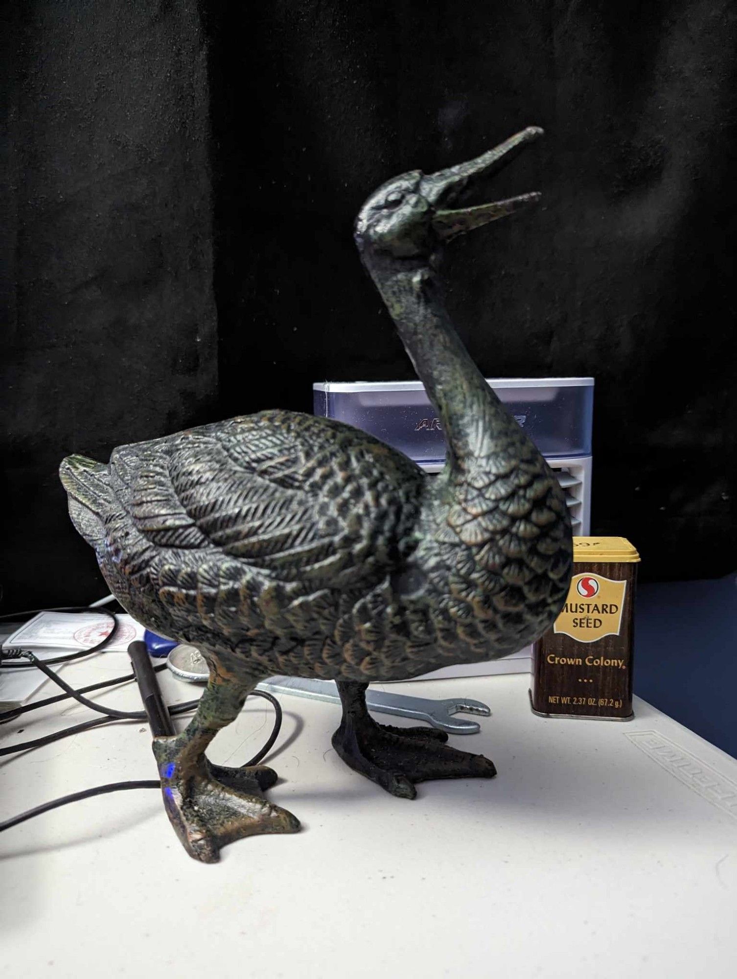 4 years later, the same black metallic goose on my desk next to a 40 year old tin of mustard seed.