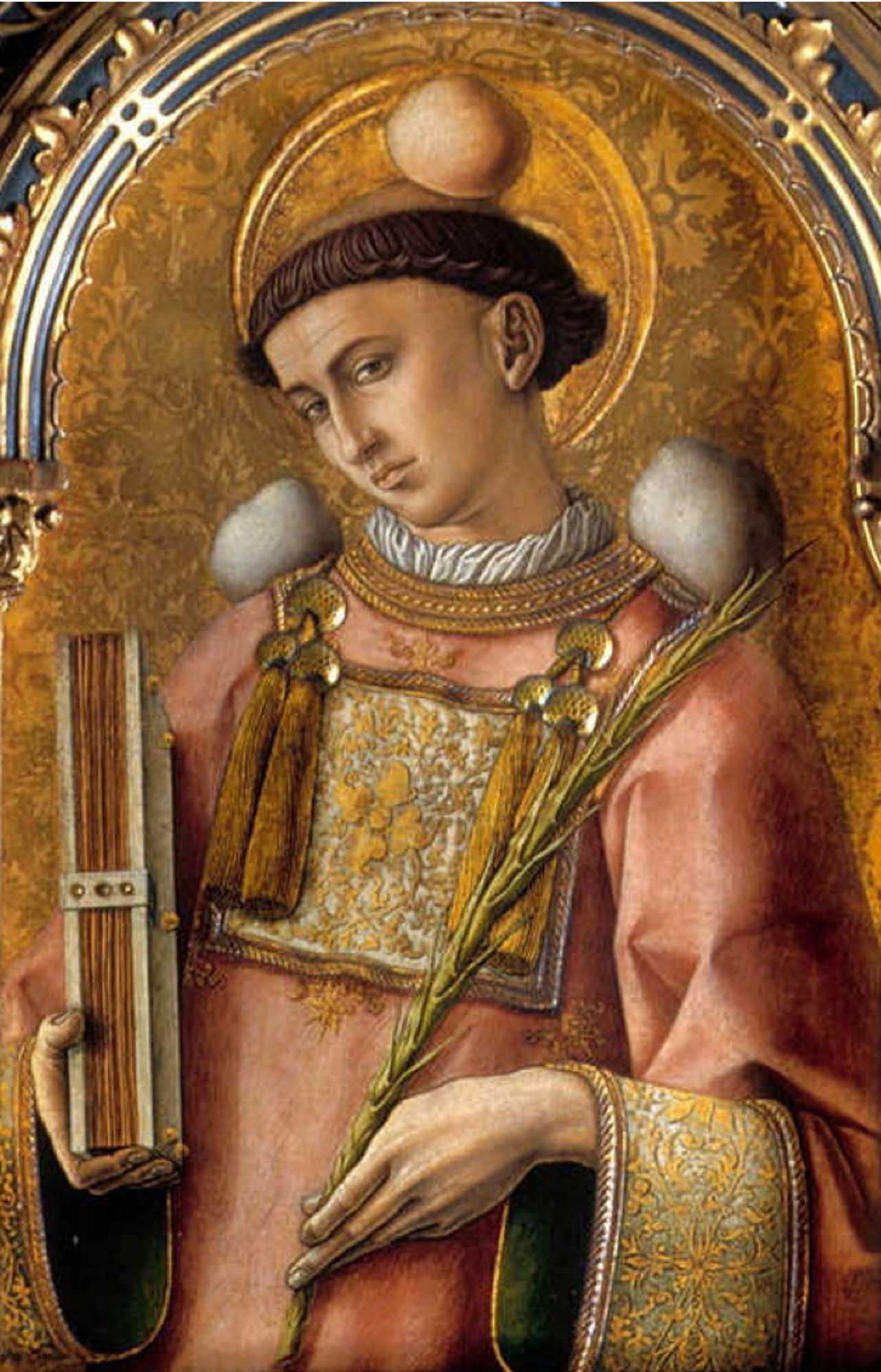 Image of St Stephen wearing a Dalmatia and with stones on his head and shoulders carrying the gospel for which he was martyred. 
— From a polyptych by Carlo Crivelli, 1476.