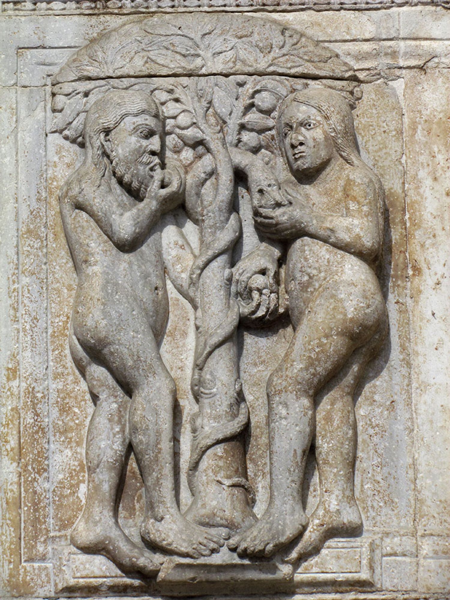 Adam and Eve stand naked, facing one another, to either side of the Tree of Knowledge. The serpent coils around the trunk and Eve takes a fruit from his mouth. With her left hand, she hands another to Adam who reaches behind the tree. Adam is already eating another fruit, while Eve watches.