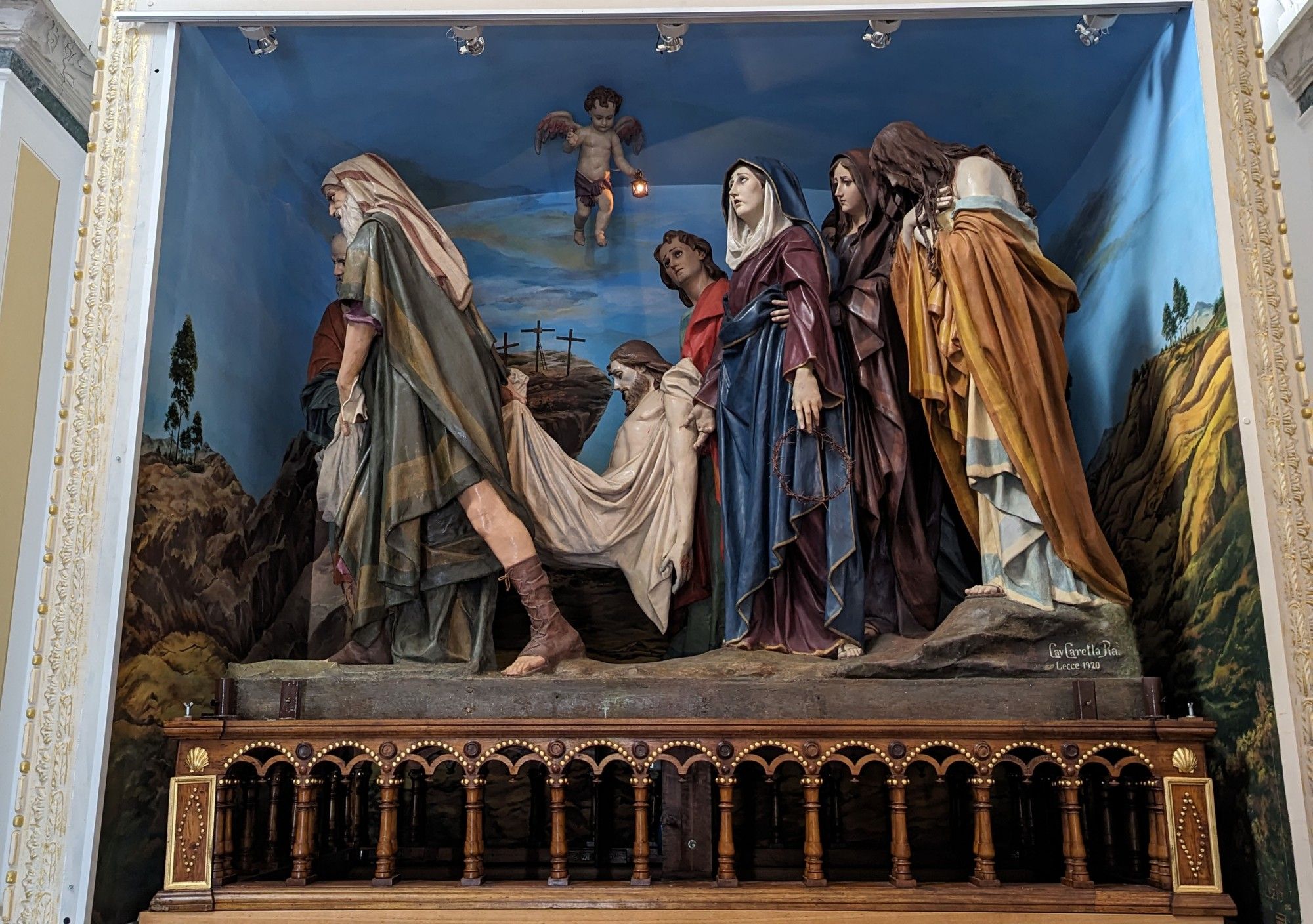 The brightly colored group of lifesize sculptures includes Nicodemus, Joseph of Arimathea, and St John carrying the dead Christ and followed by Mary, Mary Magdalen, Mary Salome, and Mary of Clopas